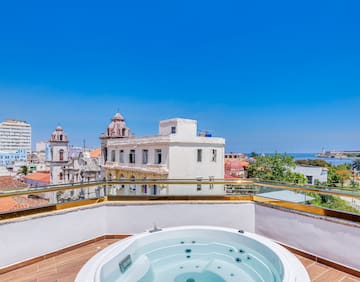 a hot tub on a rooftop overlooking a city
