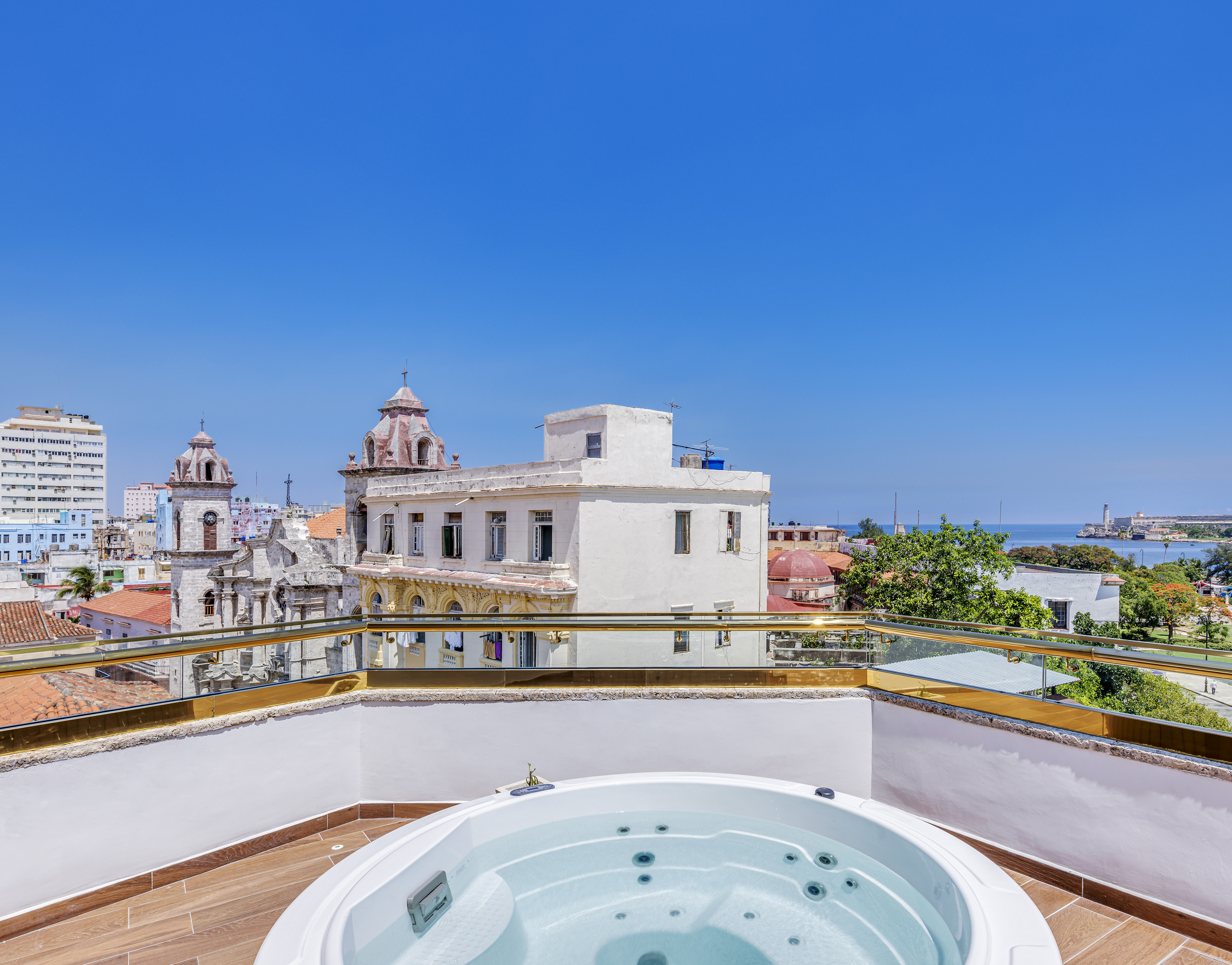 a hot tub on a rooftop overlooking a city