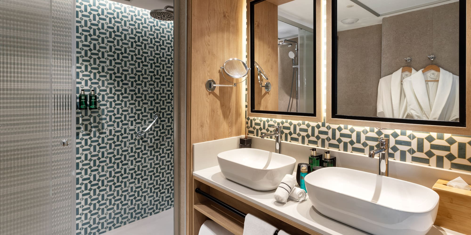 a bathroom with two sinks and a shower