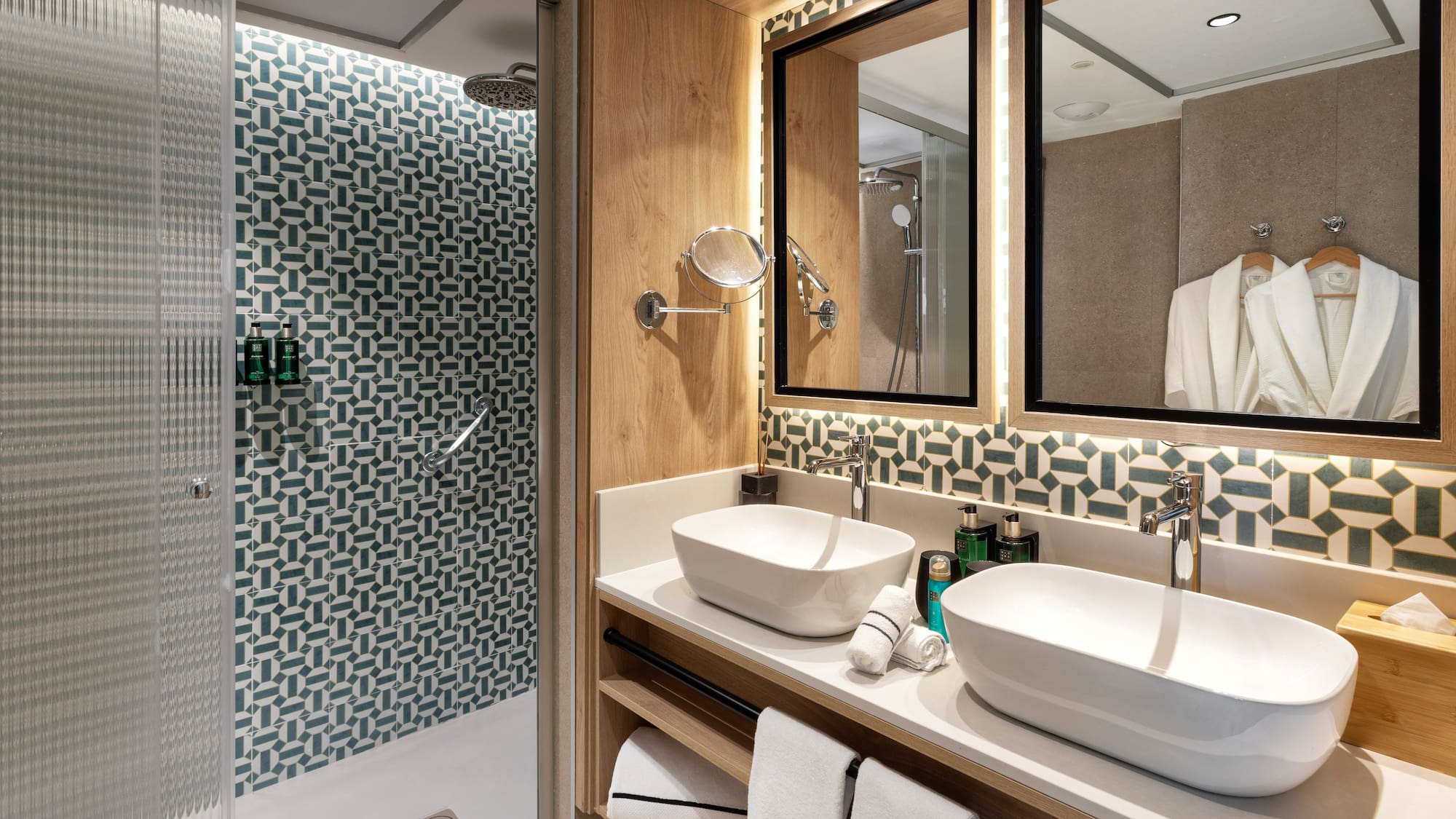 a bathroom with two sinks and a shower