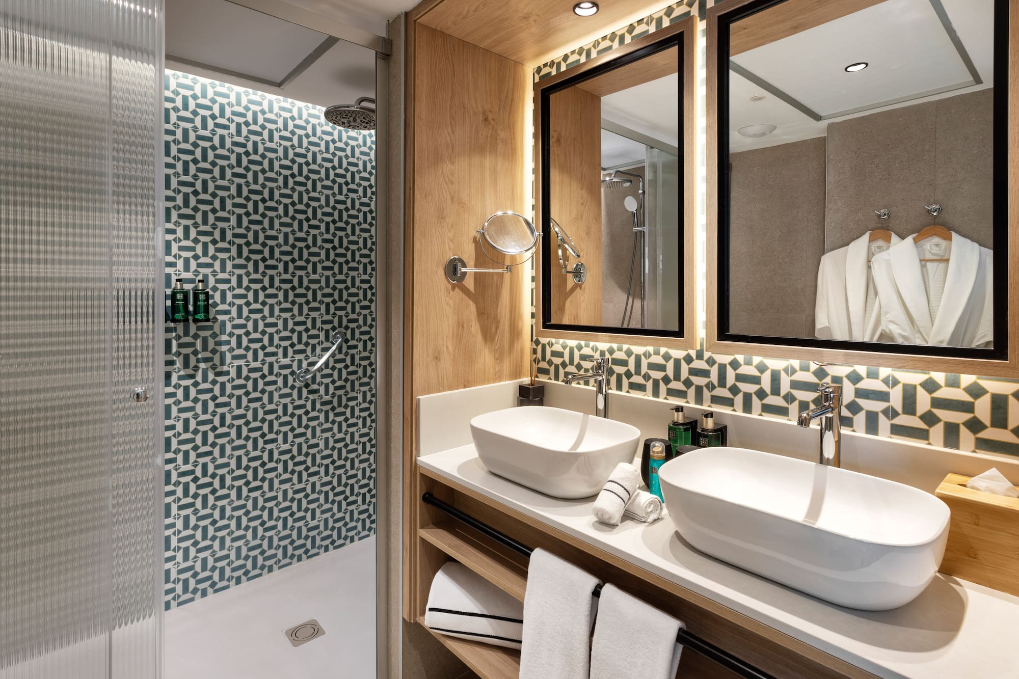 a bathroom with two sinks and a shower