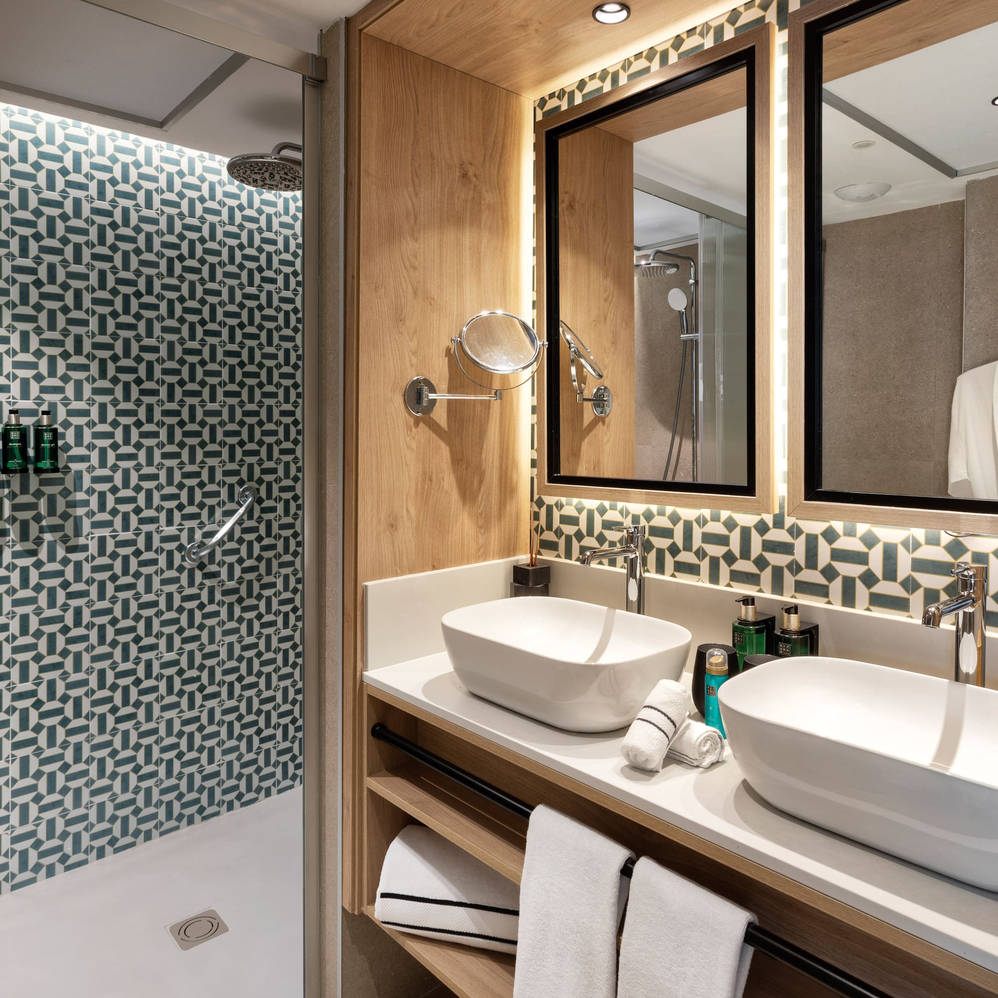 a bathroom with two sinks and a shower