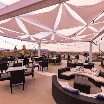 a patio with tables and chairs