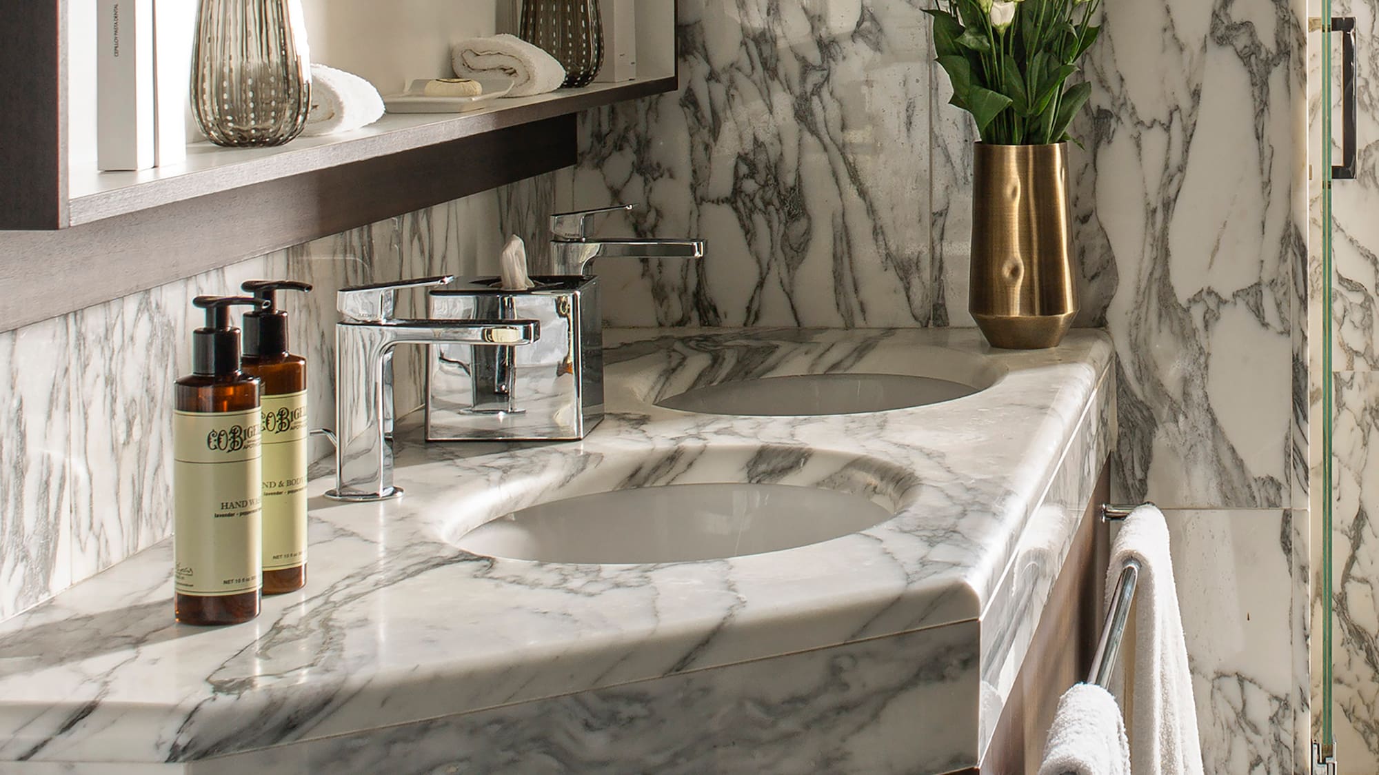 a bathroom with marble countertop and mirror