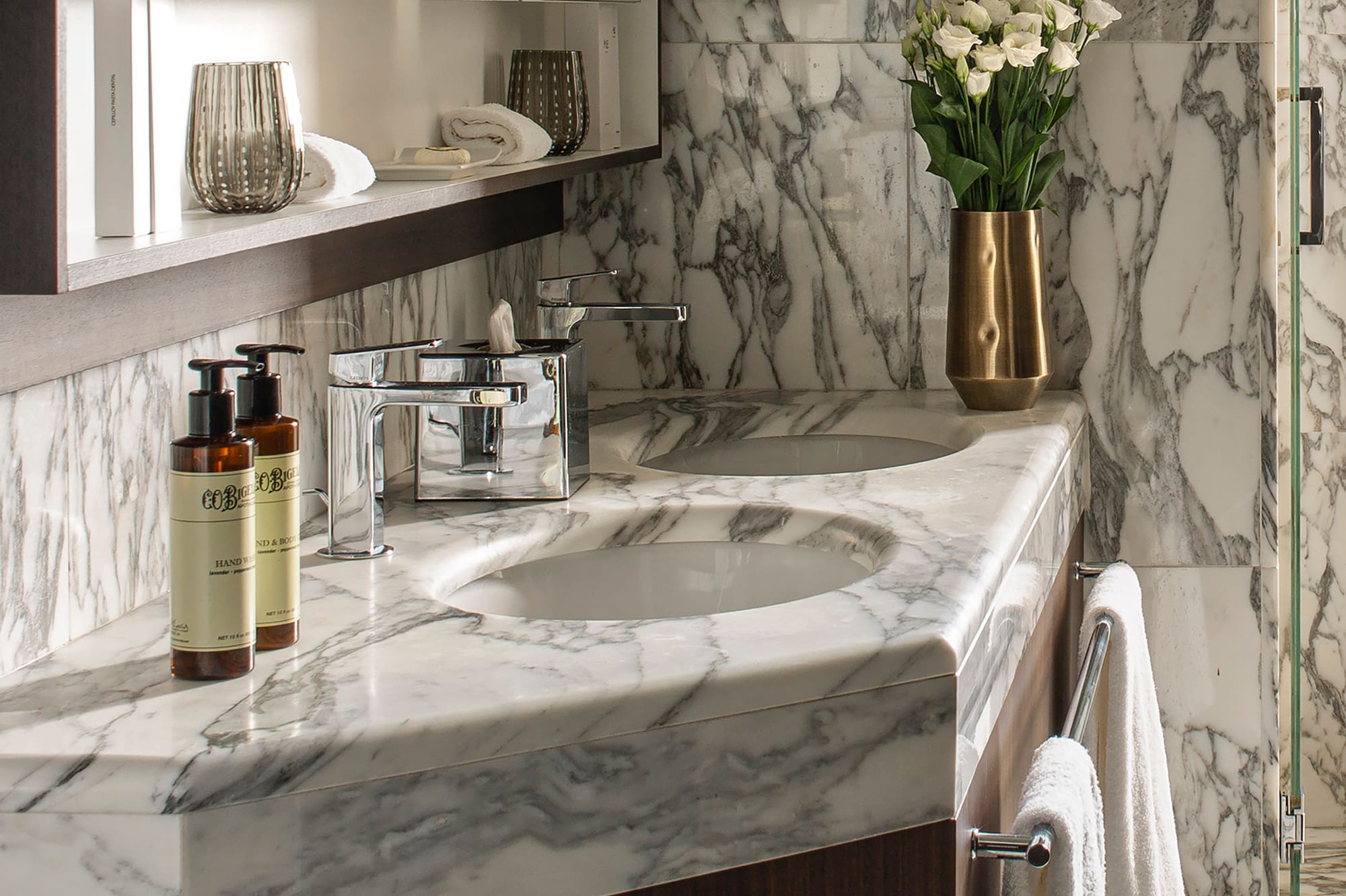 a bathroom with marble countertop and mirror