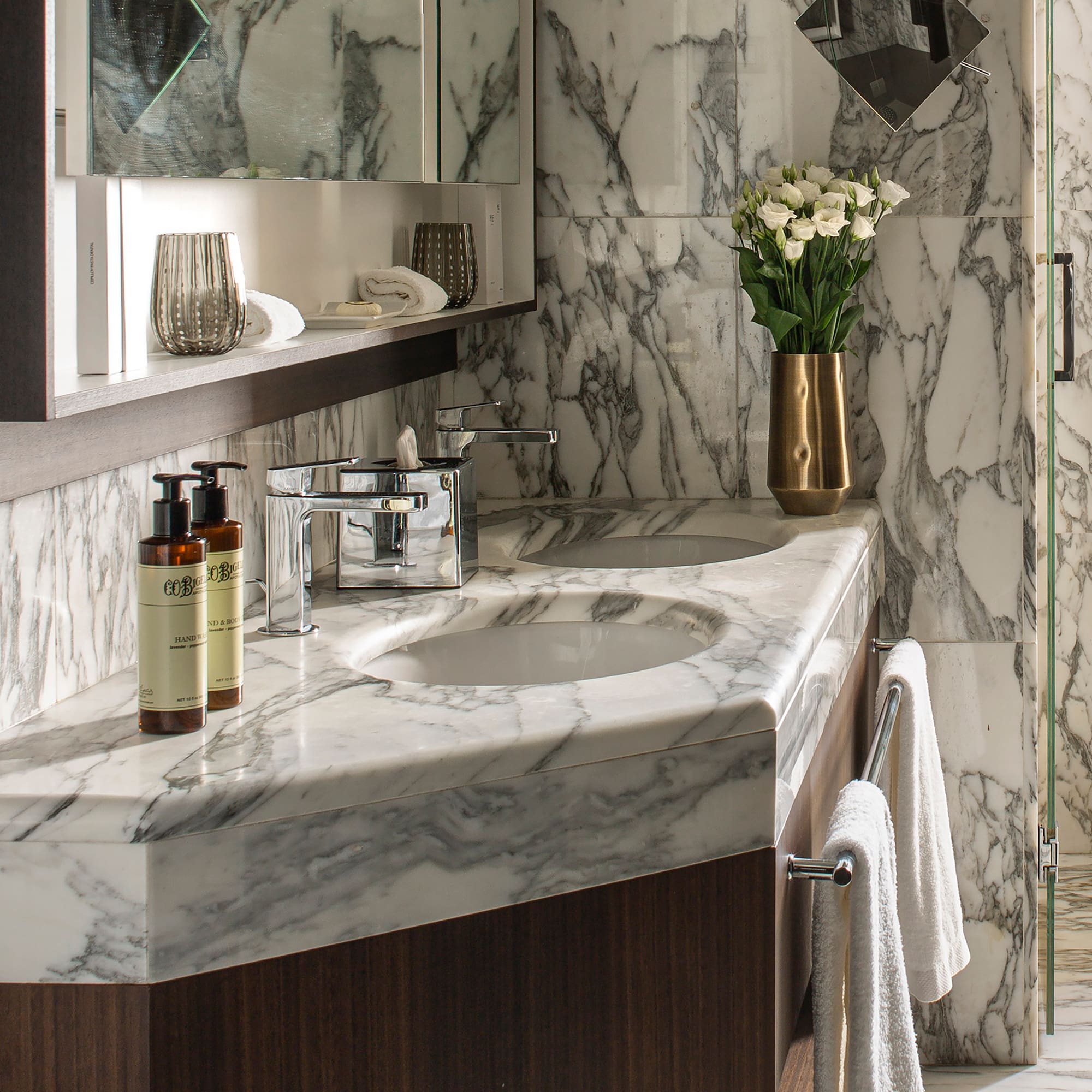 a bathroom with marble countertop and mirror