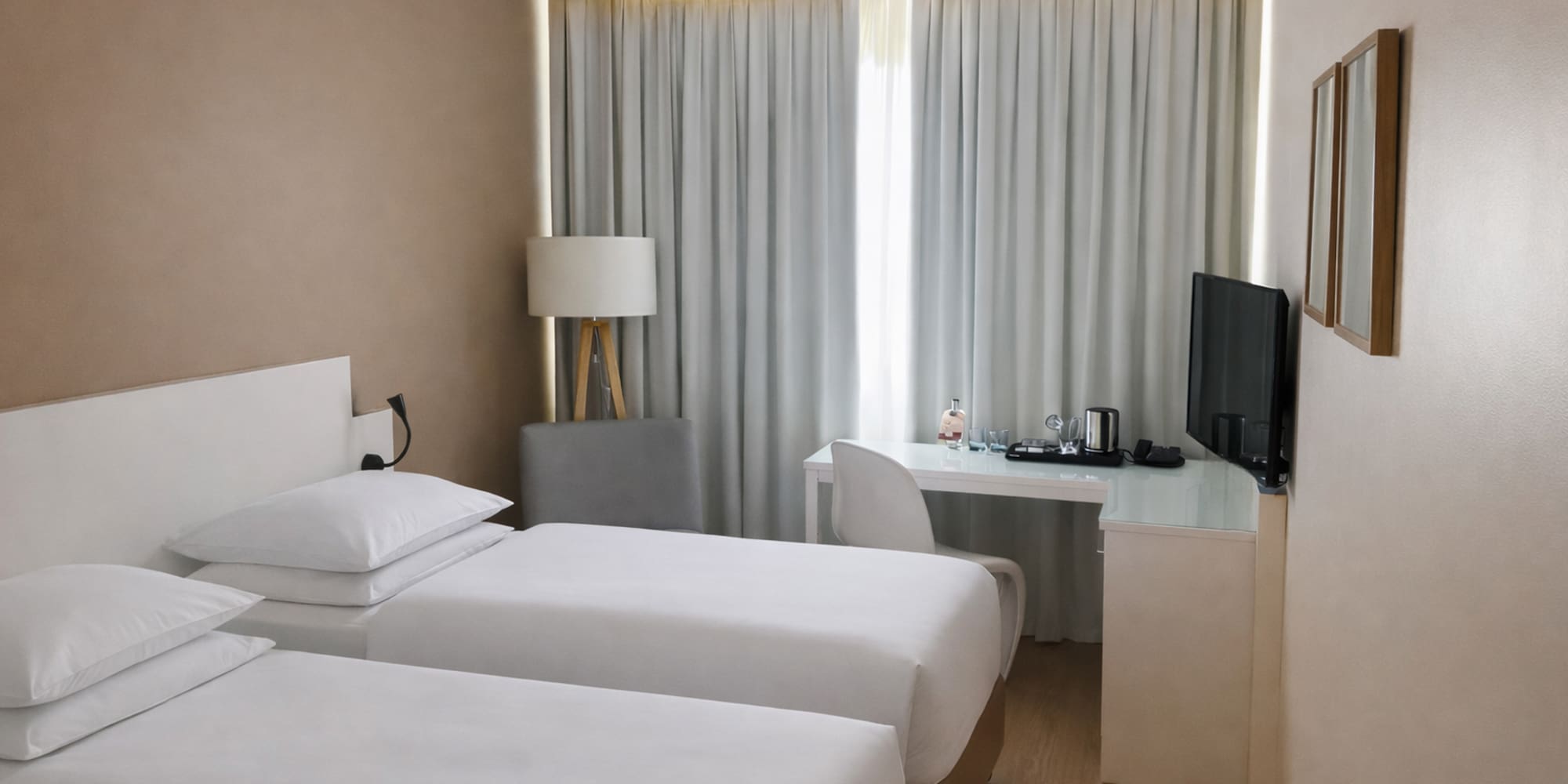 a room with two beds and a desk