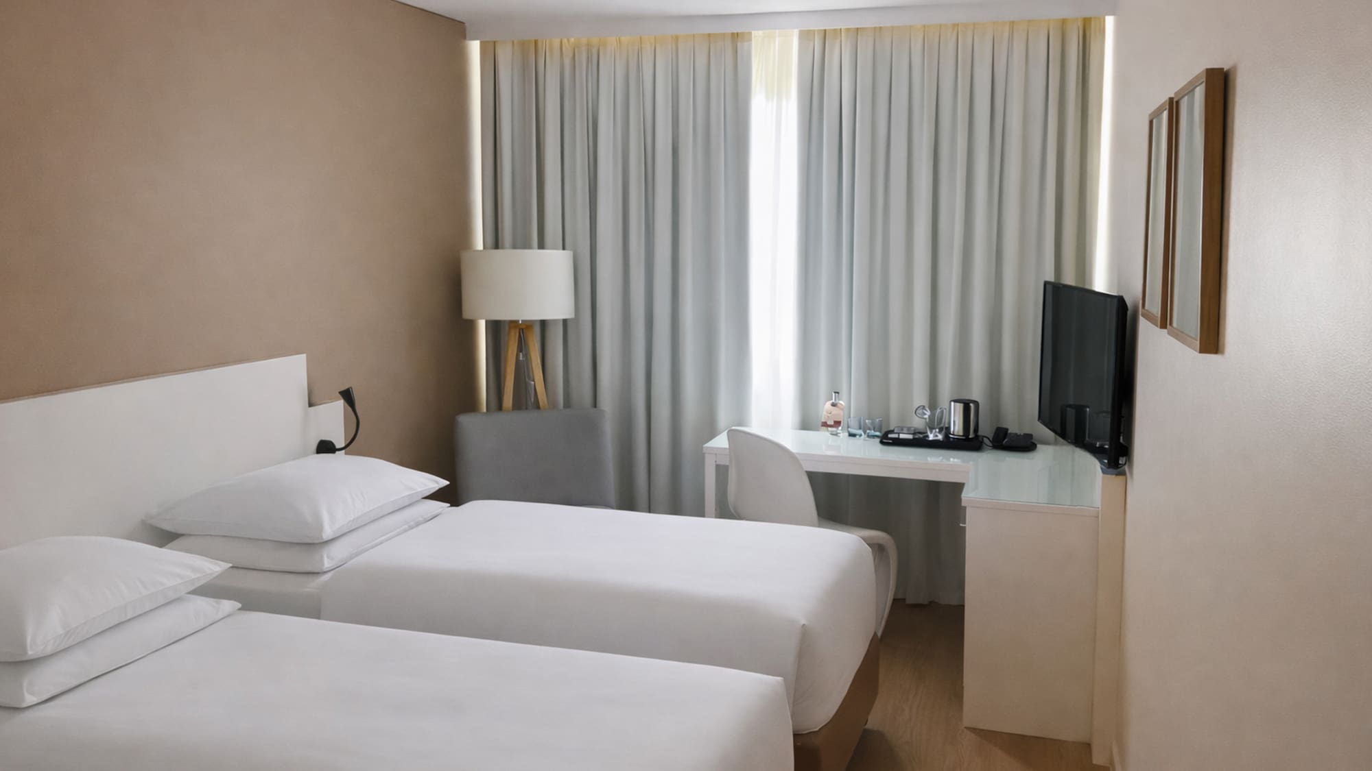 a room with two beds and a desk