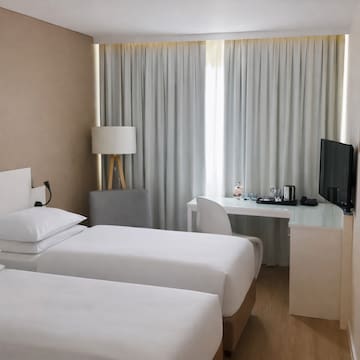 a room with two beds and a desk