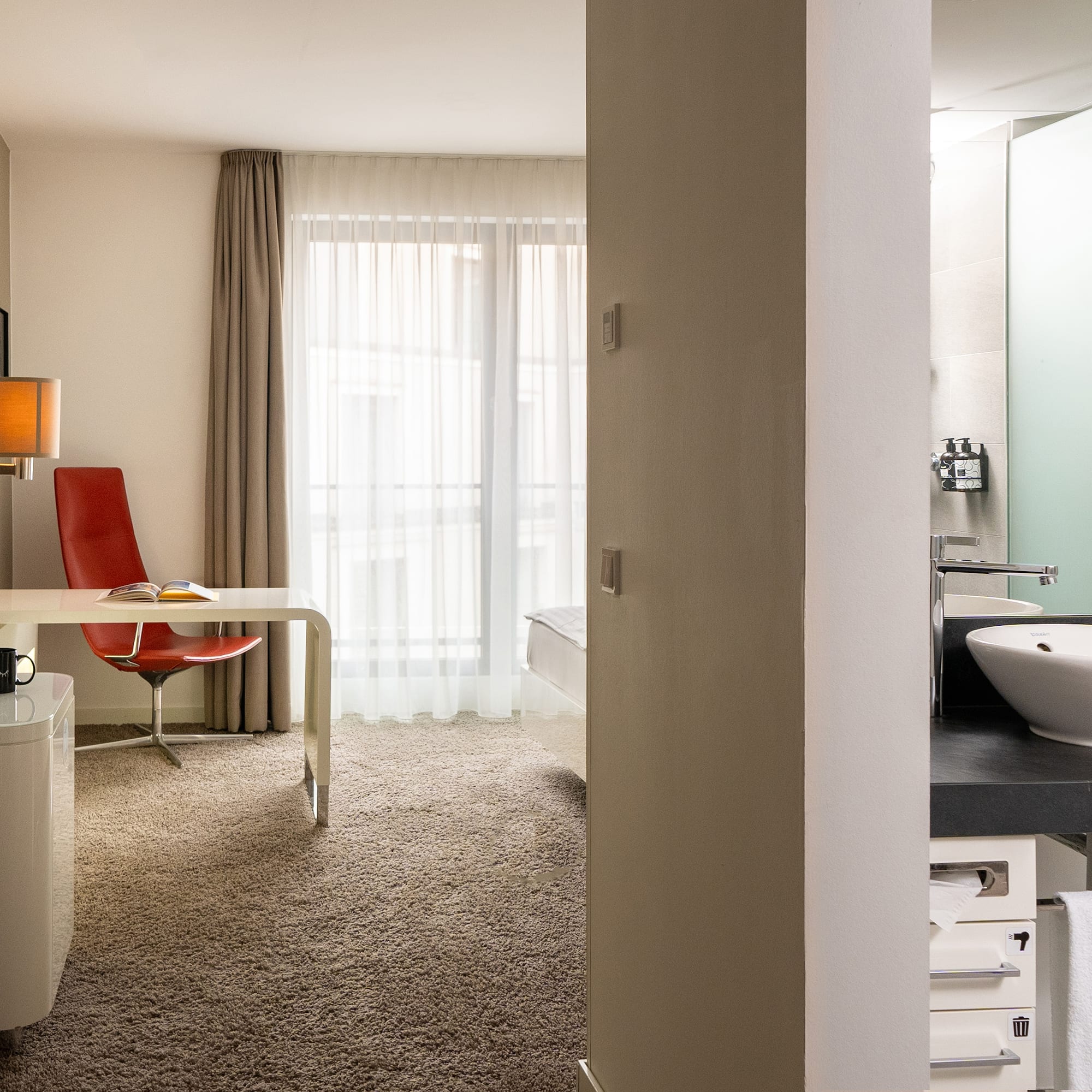 a room with a desk and a sink