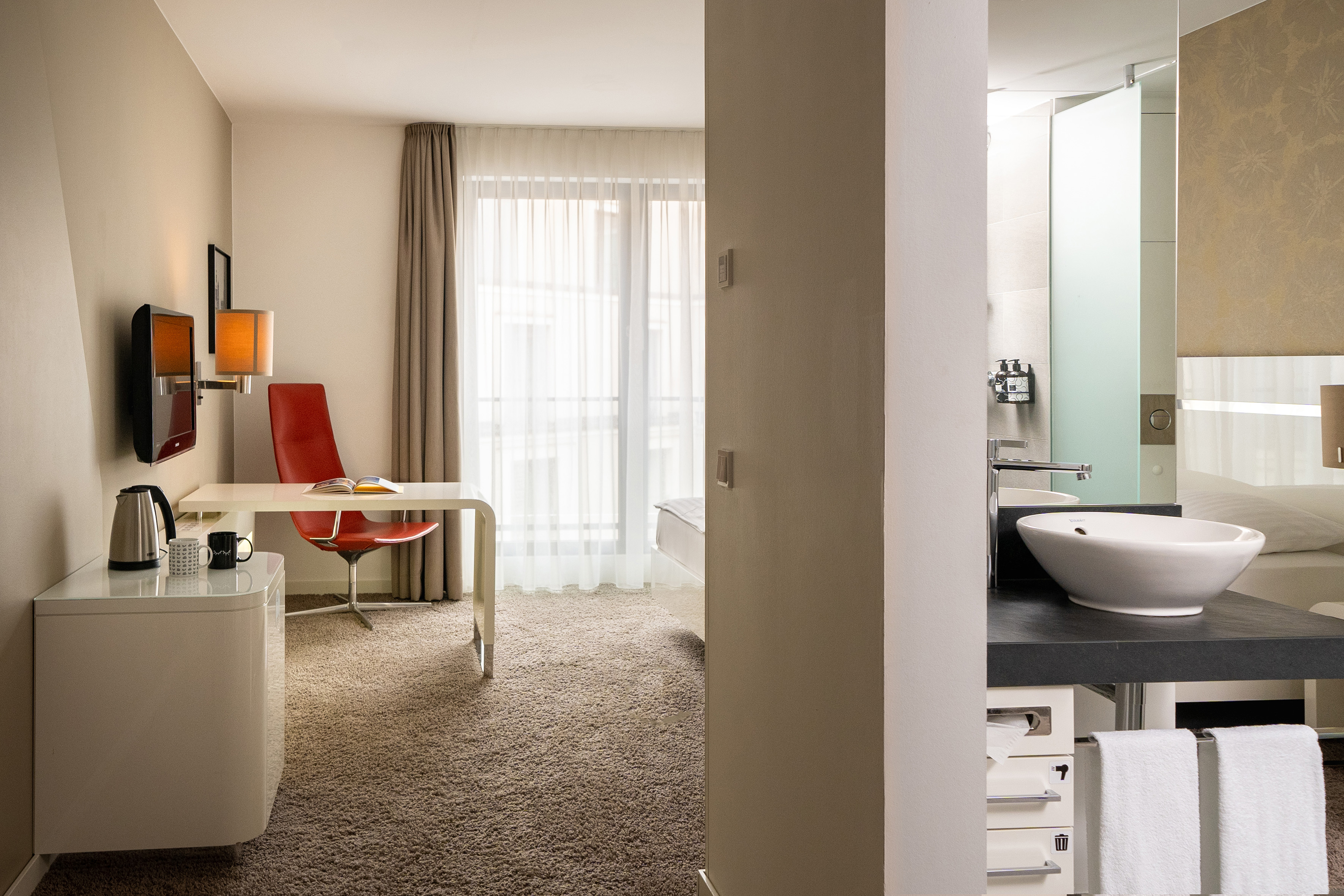 a room with a desk and a sink