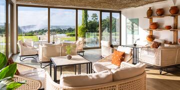 a room with wicker furniture and a large window