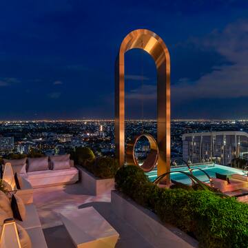 a rooftop with a pool and a large arch