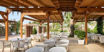a patio with tables and chairs