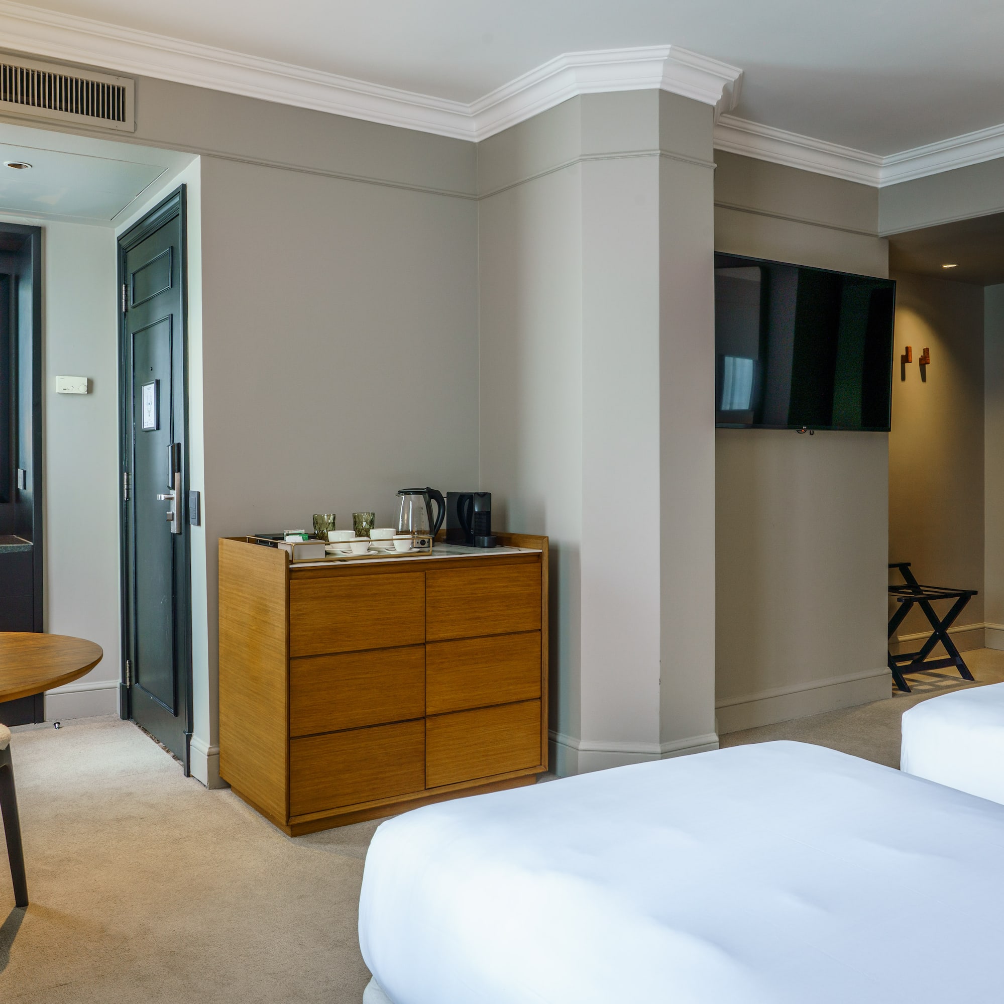 a room with two beds and a television