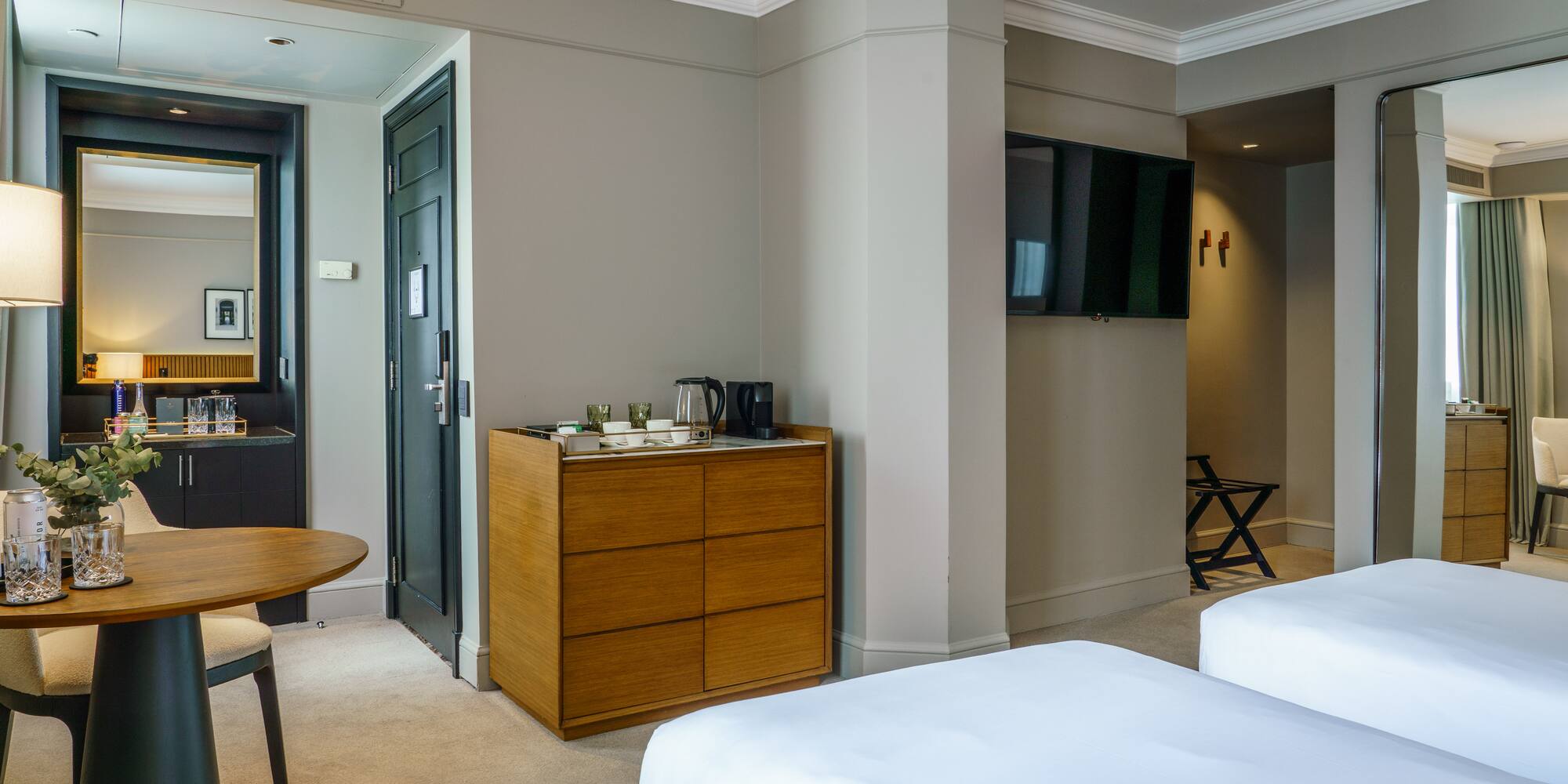 a room with two beds and a television