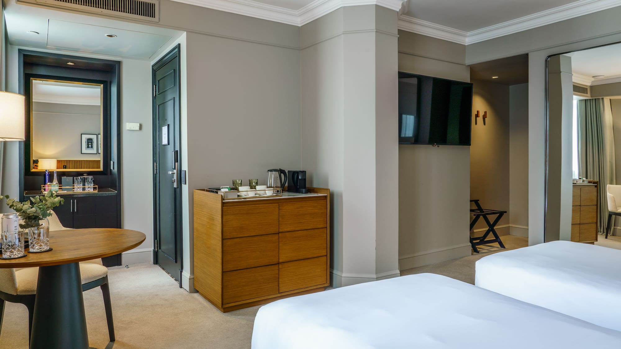 a room with two beds and a television