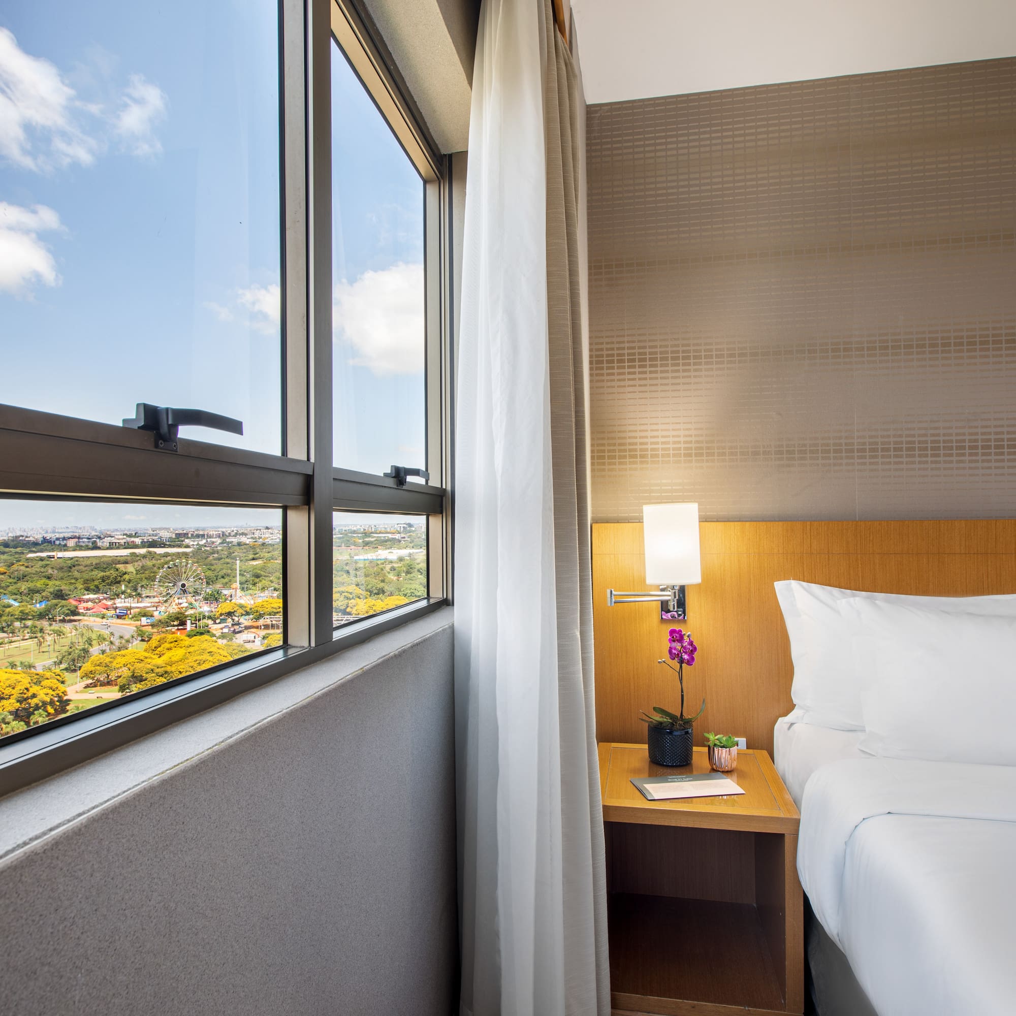 a bedroom with a window and a view of a valley