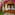 Tropical outdoor spa cabana draped in pink bougainvillea, two massage beds.