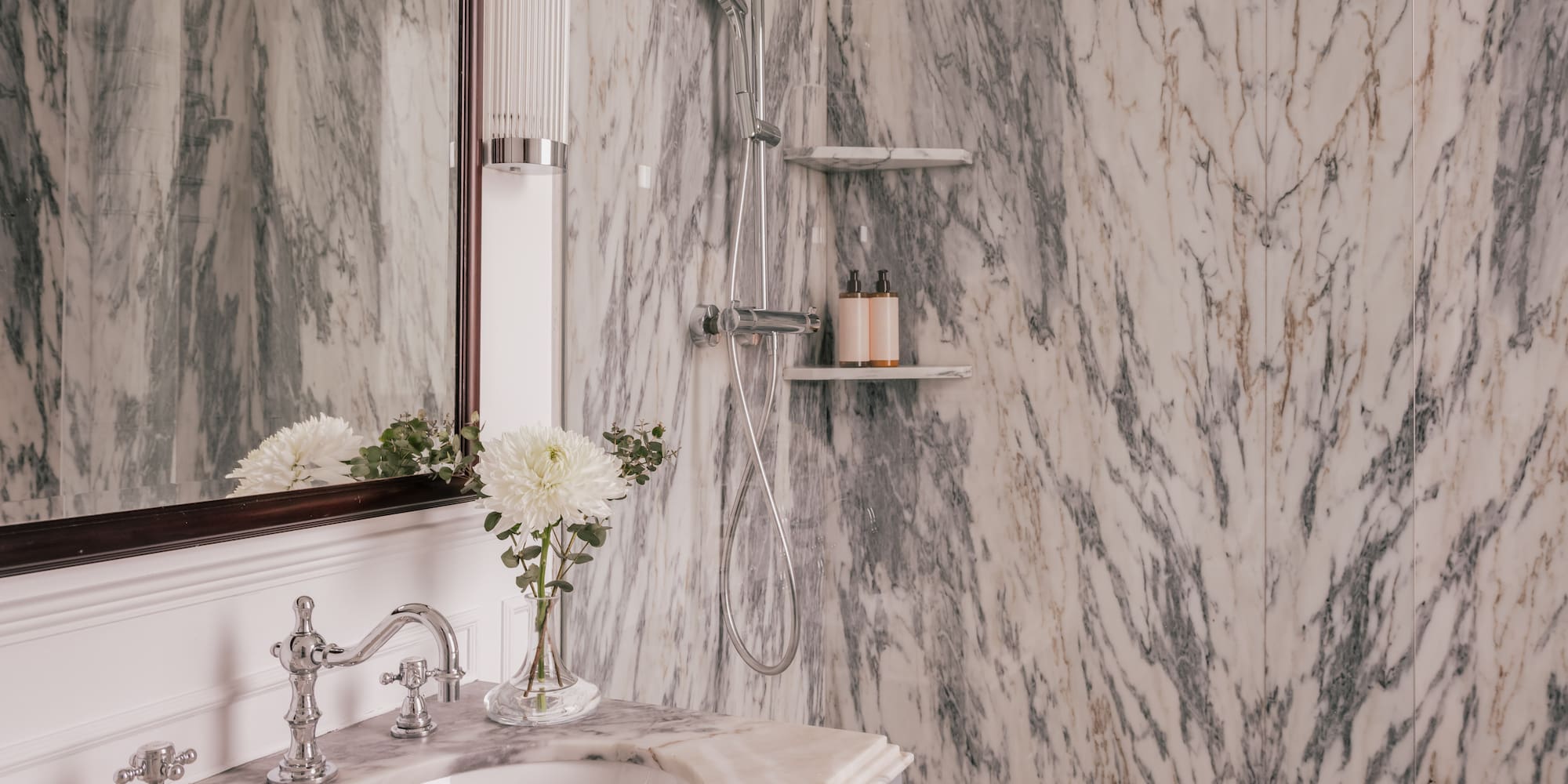 a bathroom with marble walls and a sink