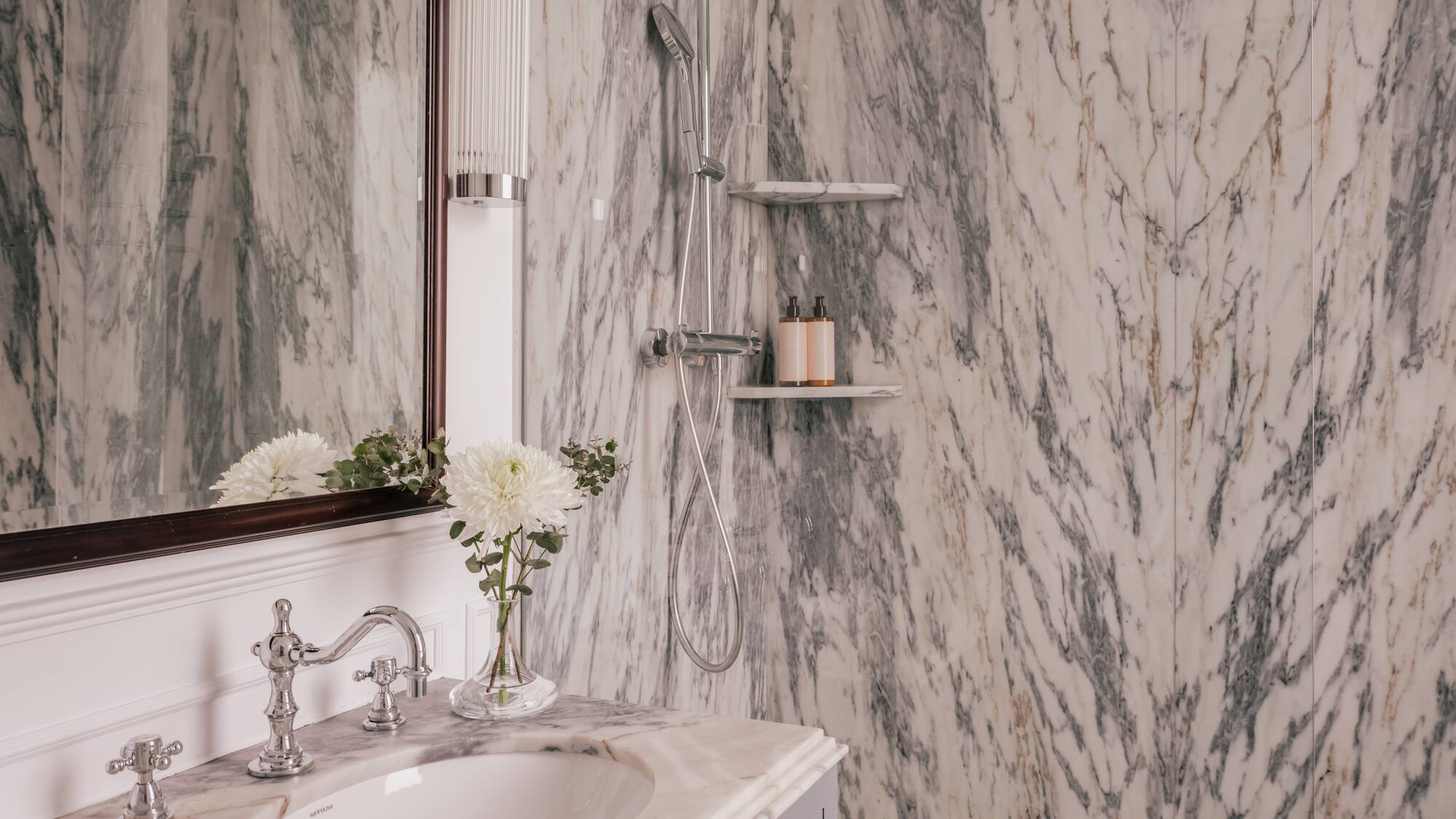 a bathroom with marble walls and a sink