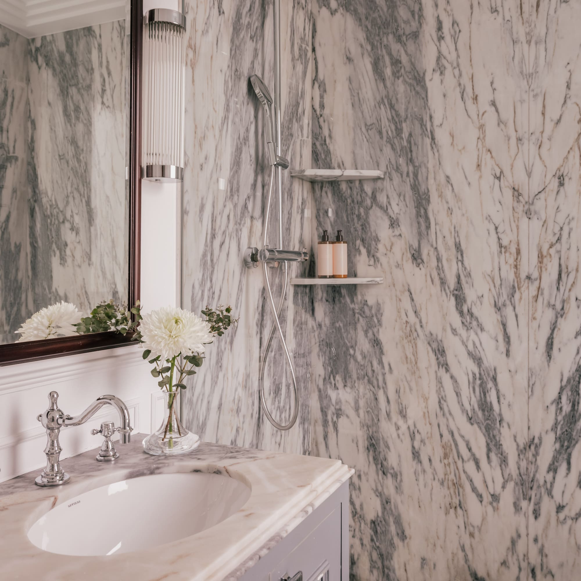 a bathroom with marble walls and a sink
