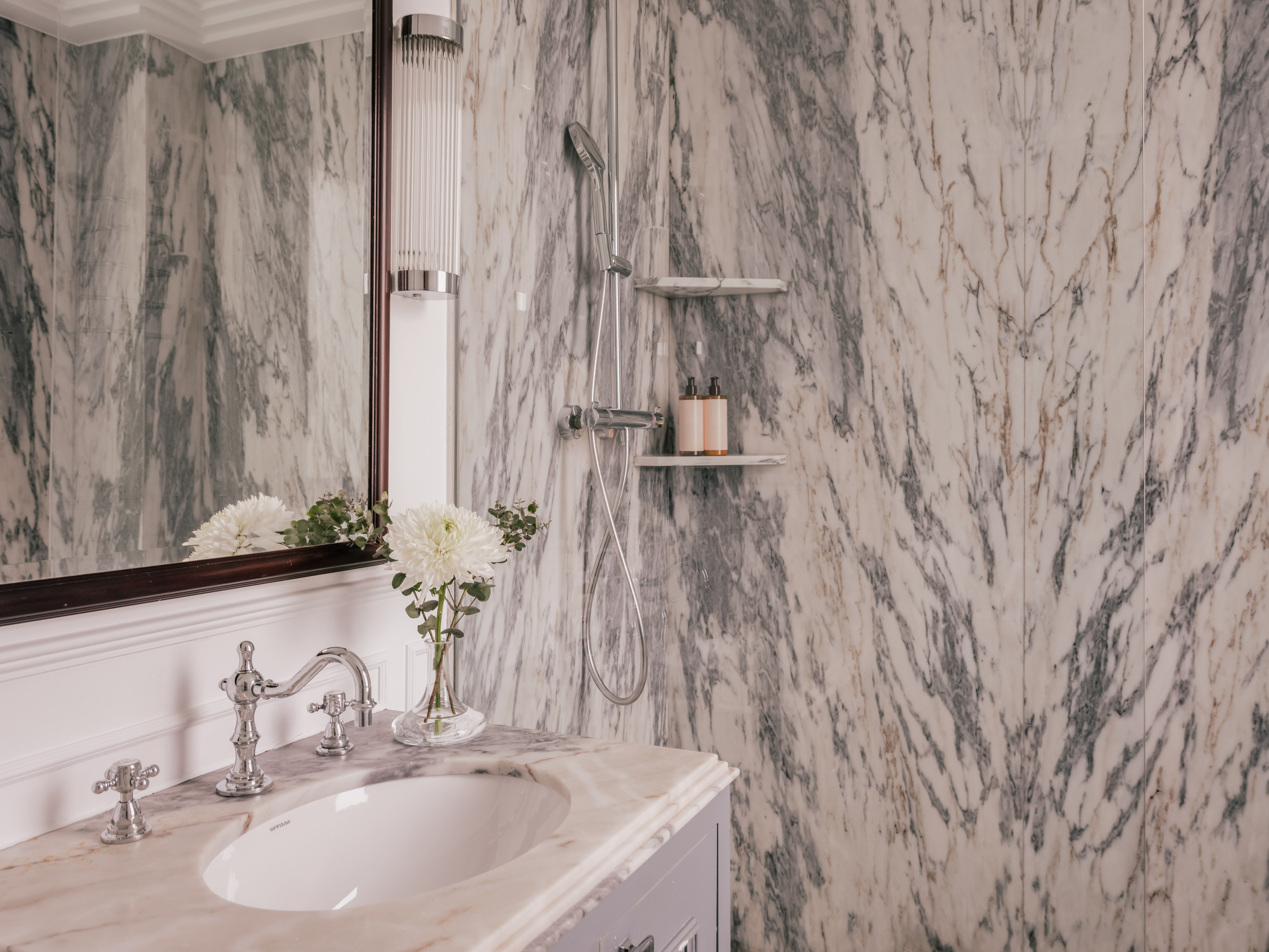 a bathroom with marble walls and a sink