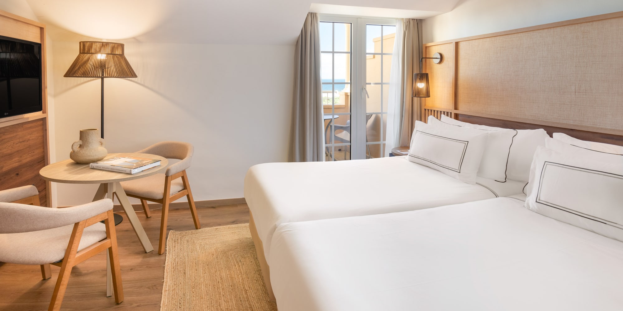 a room with two beds and a table