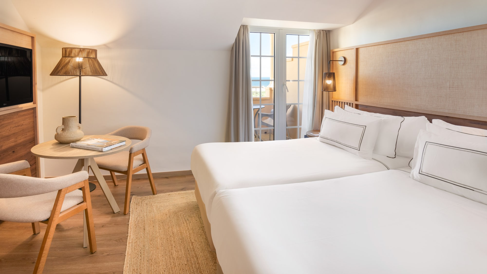 a room with two beds and a table