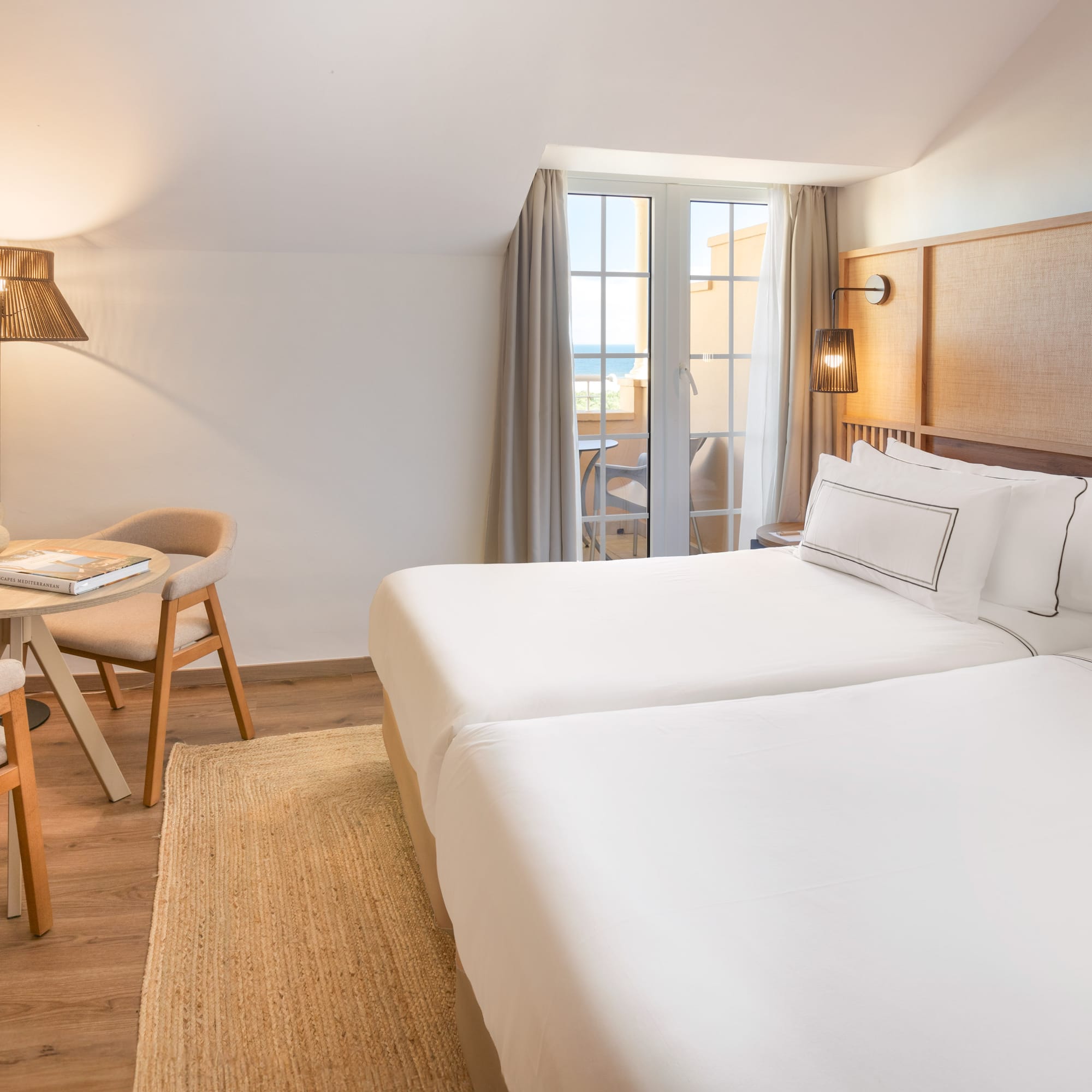 a room with two beds and a table