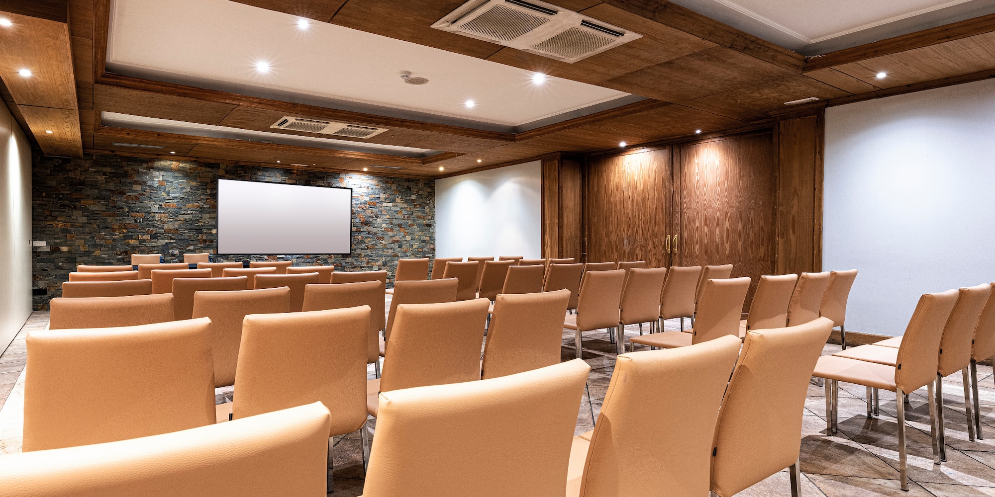a room with chairs and a screen