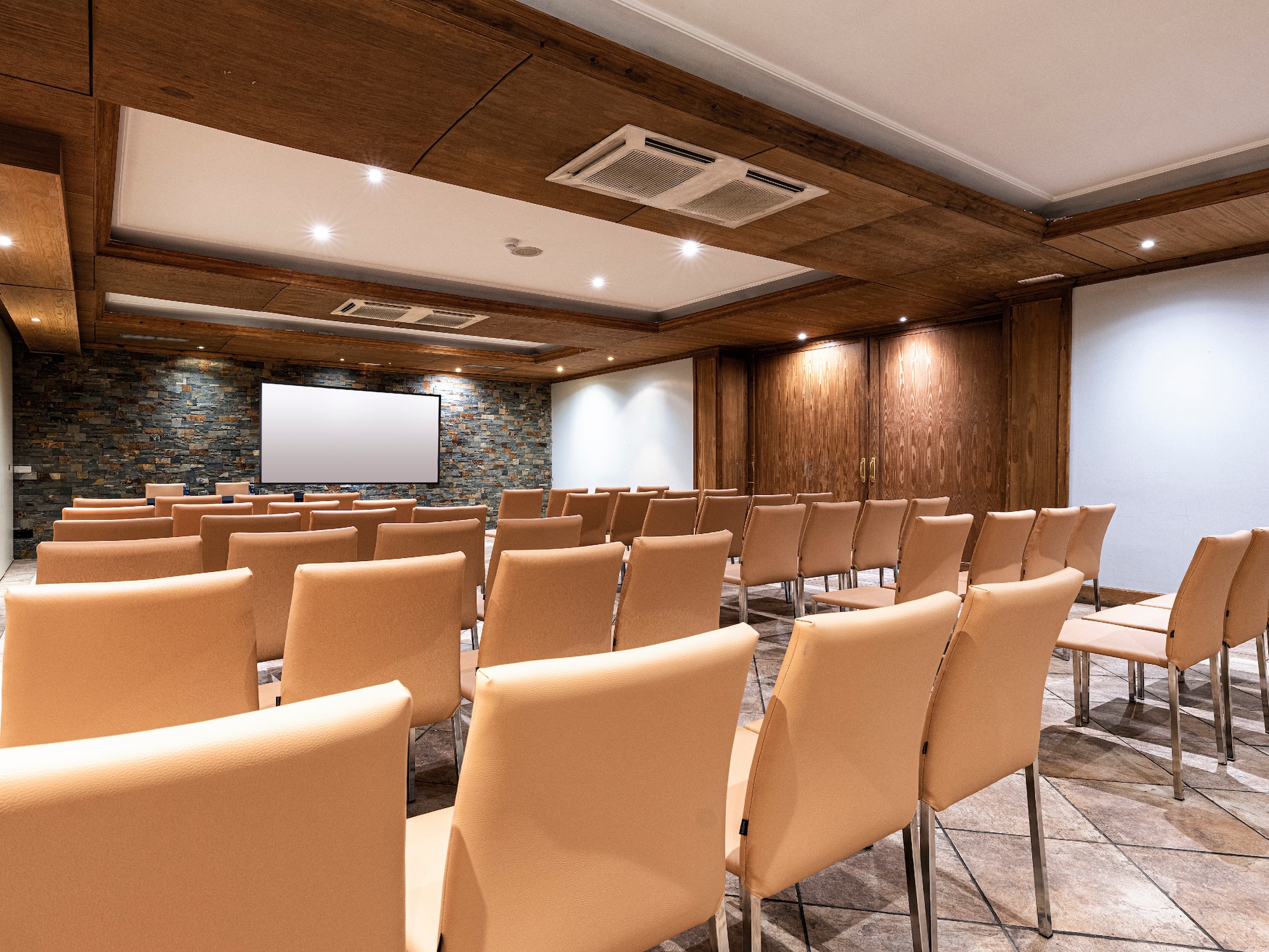 a room with chairs and a screen