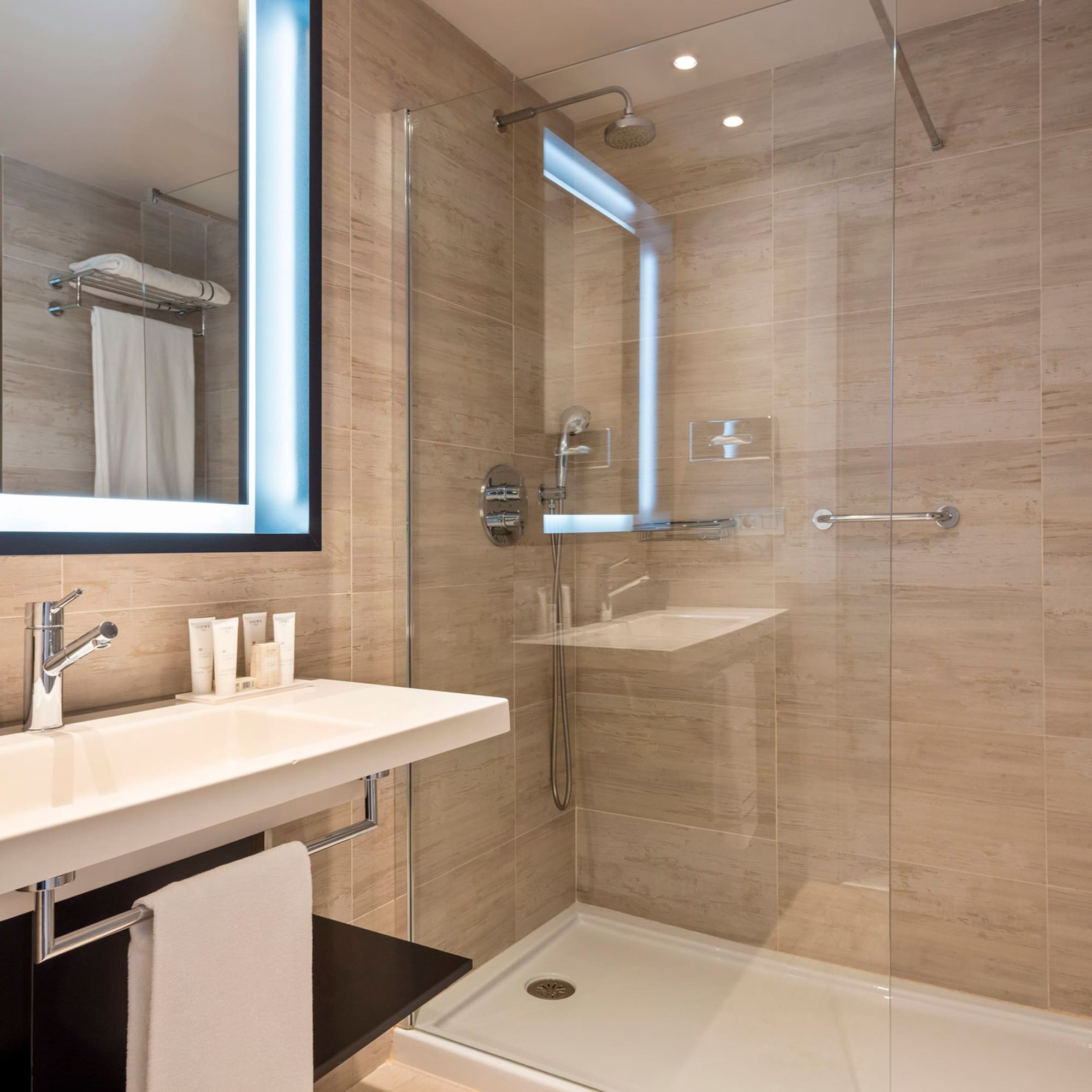 a bathroom with a glass shower and a sink