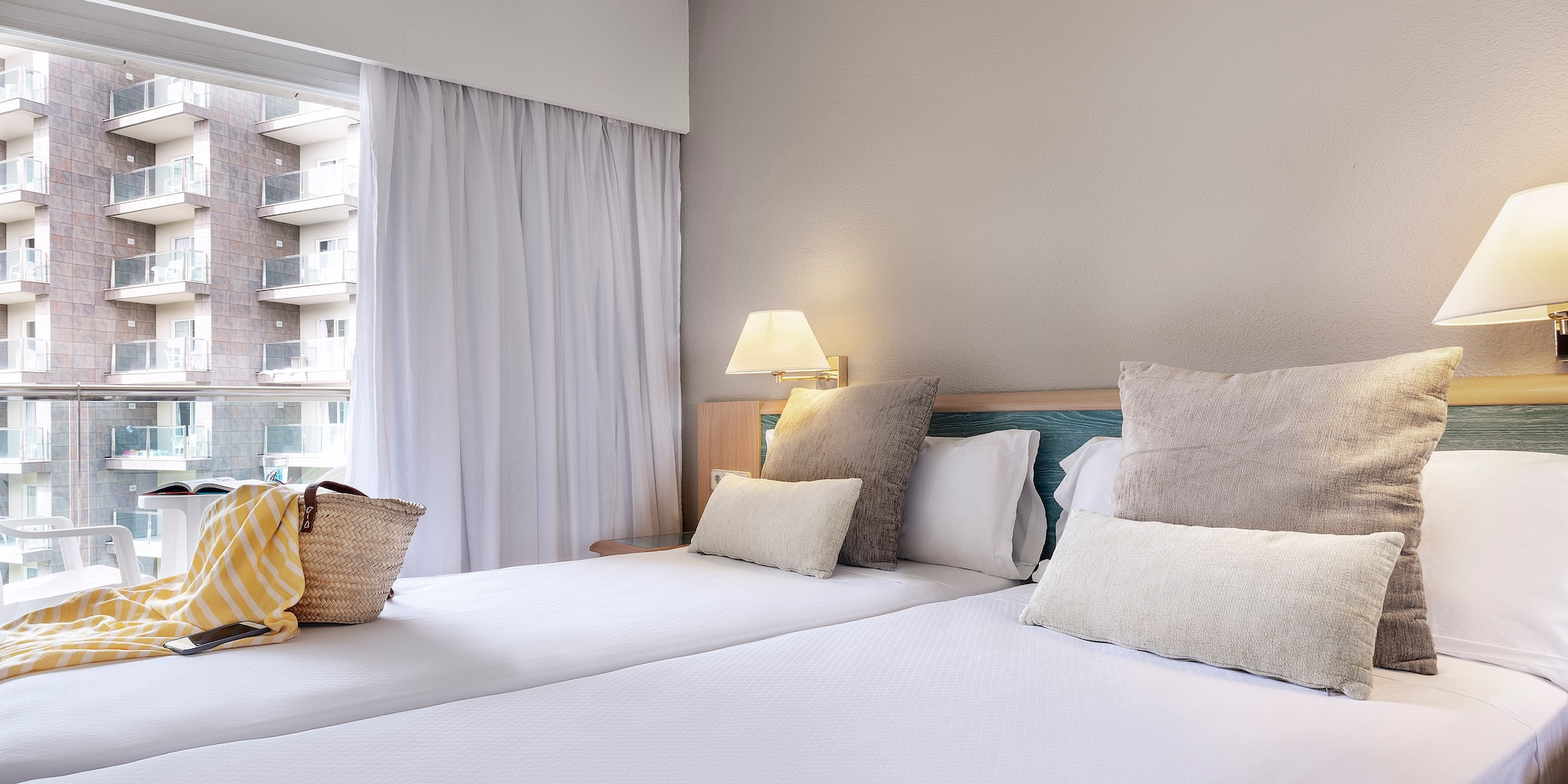 a bed with pillows and a bag on it