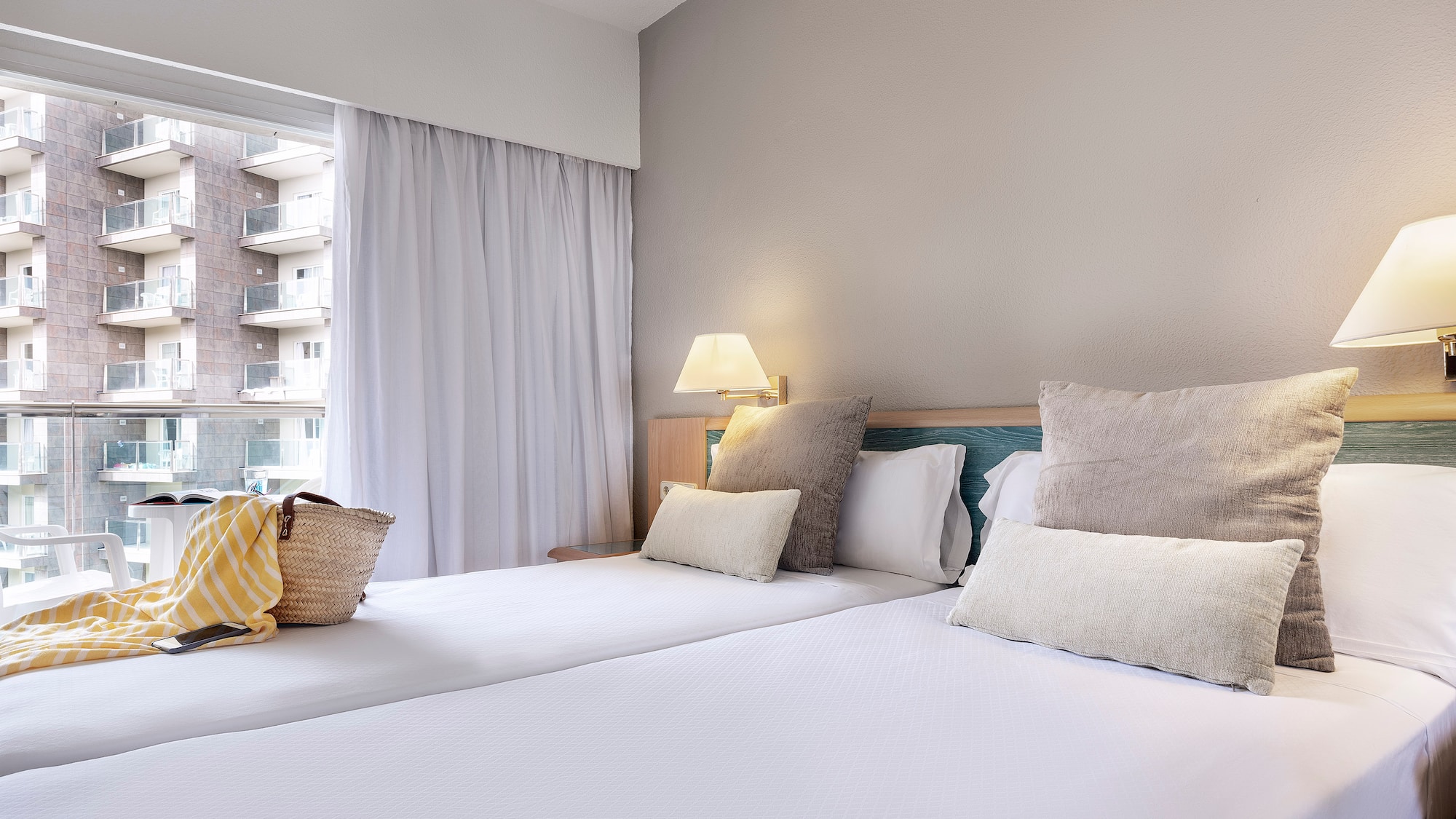 a bed with pillows and a bag on it