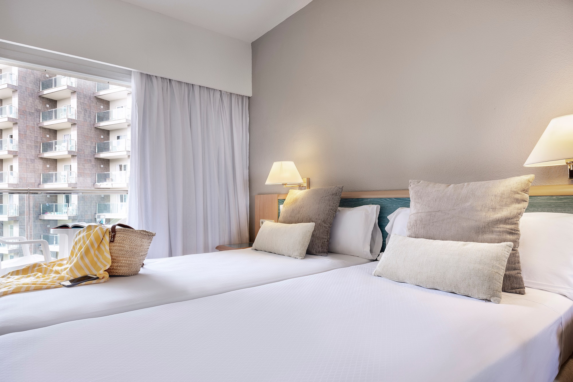 a bed with pillows and a bag on it