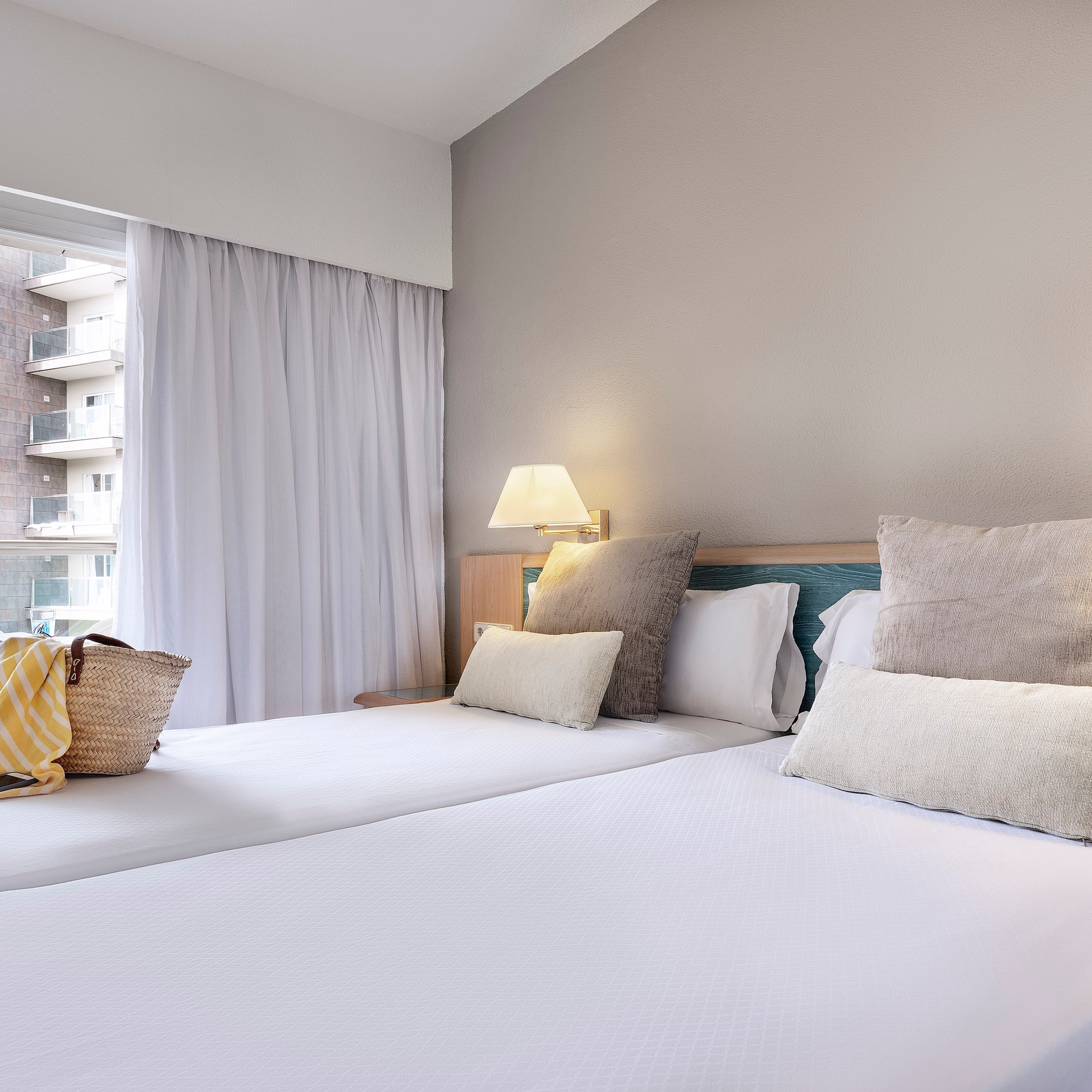 a bed with pillows and a bag on it