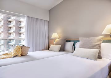 a bed with pillows and a bag on it