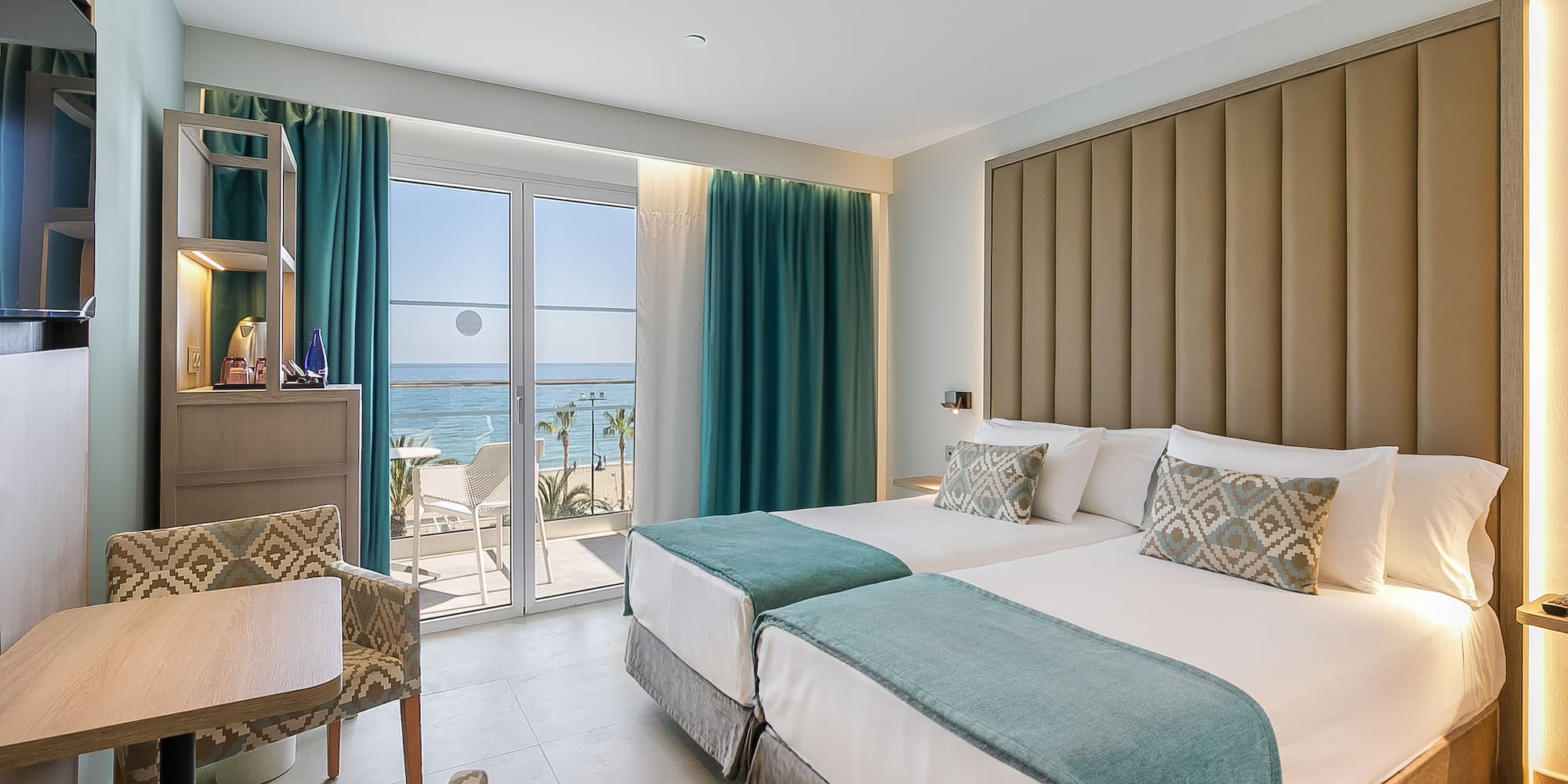 a room with two beds and a glass door