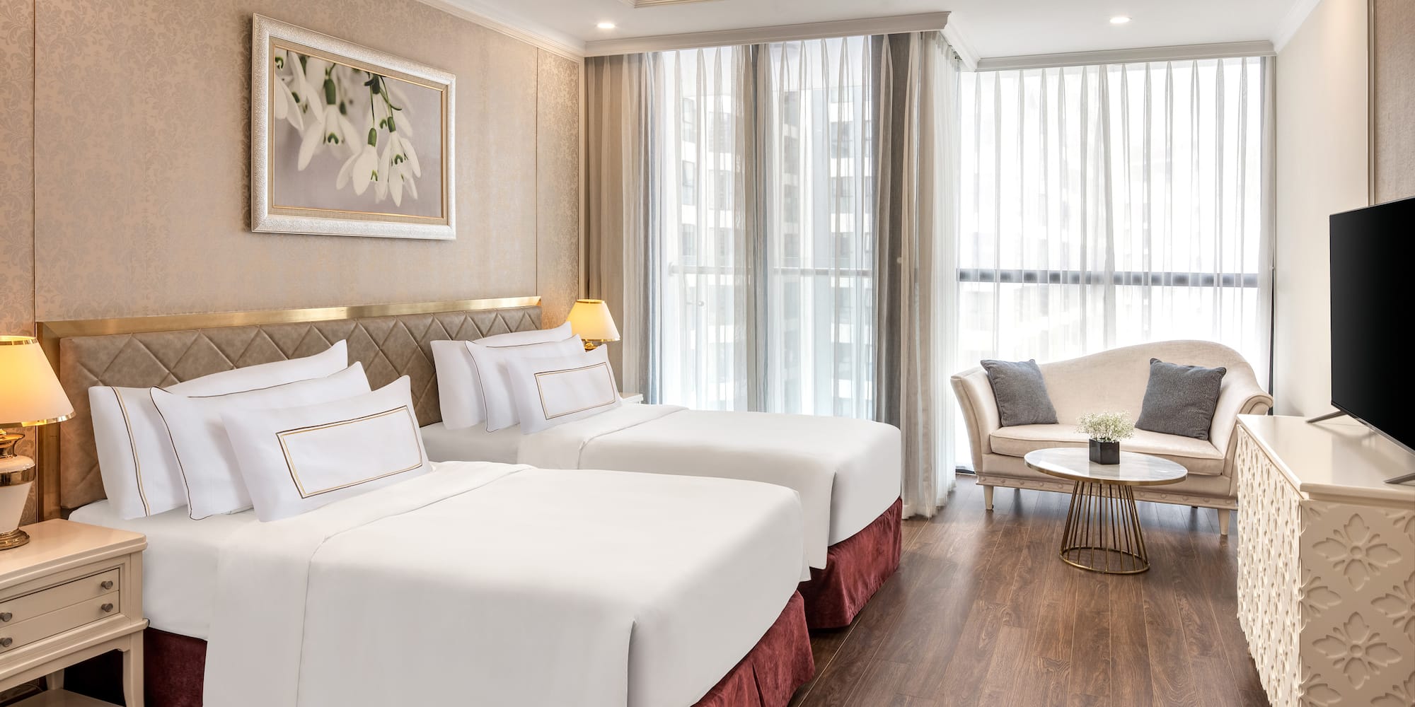 a room with two beds and a couch