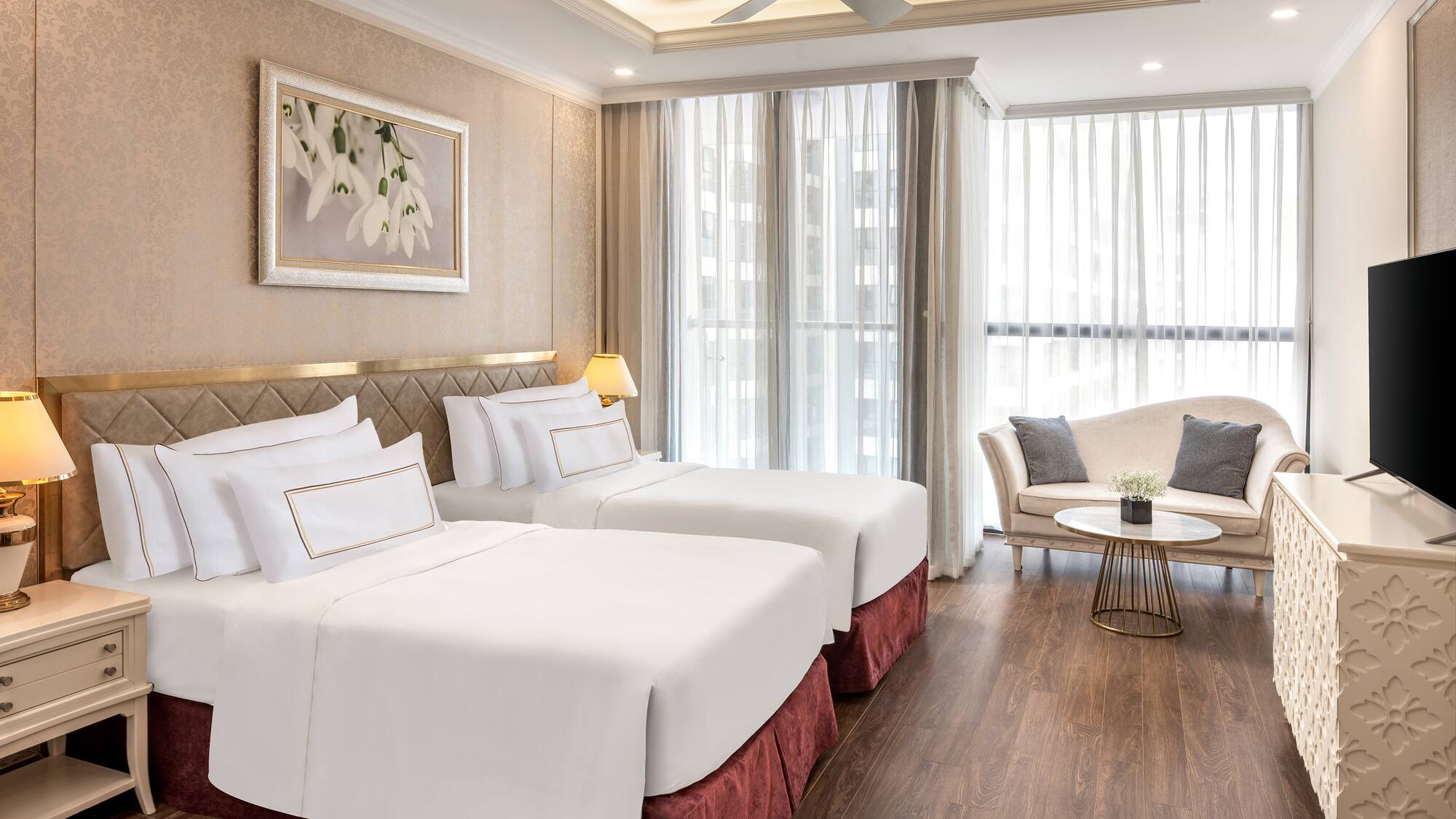 a room with two beds and a couch