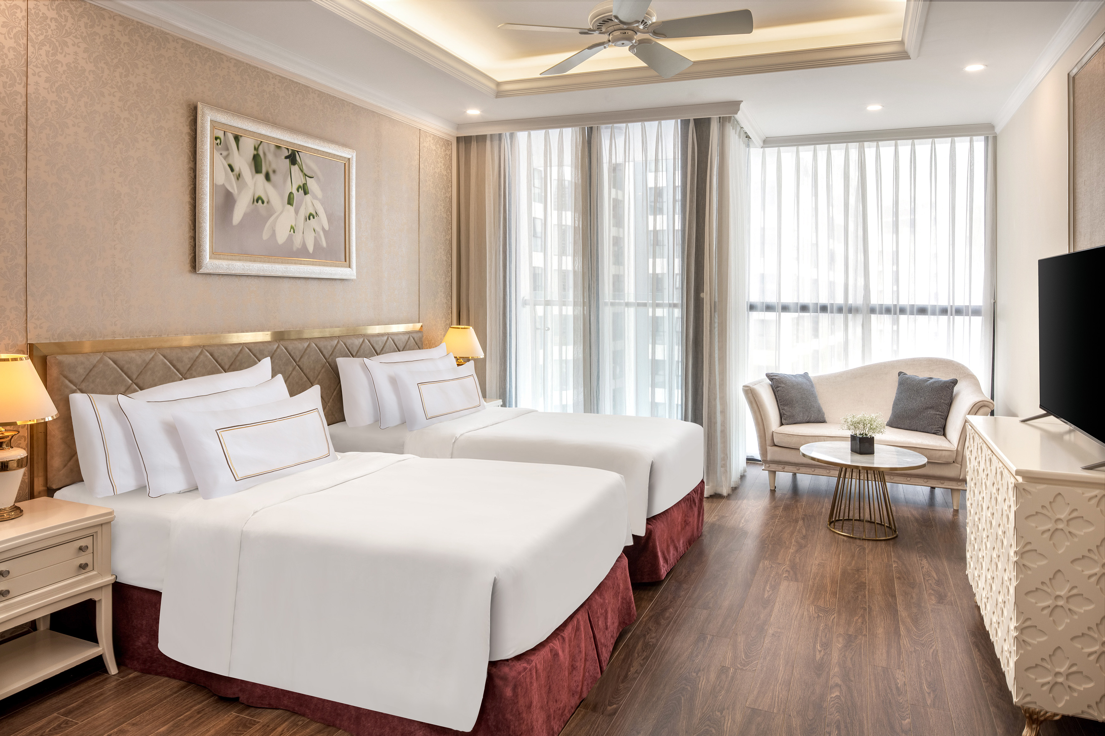 a room with two beds and a couch