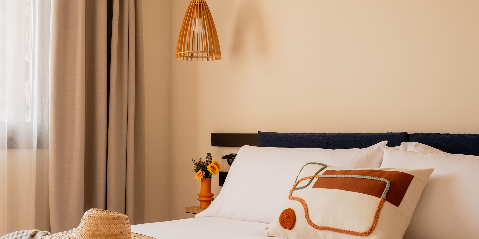 a bed with a hat and pillow