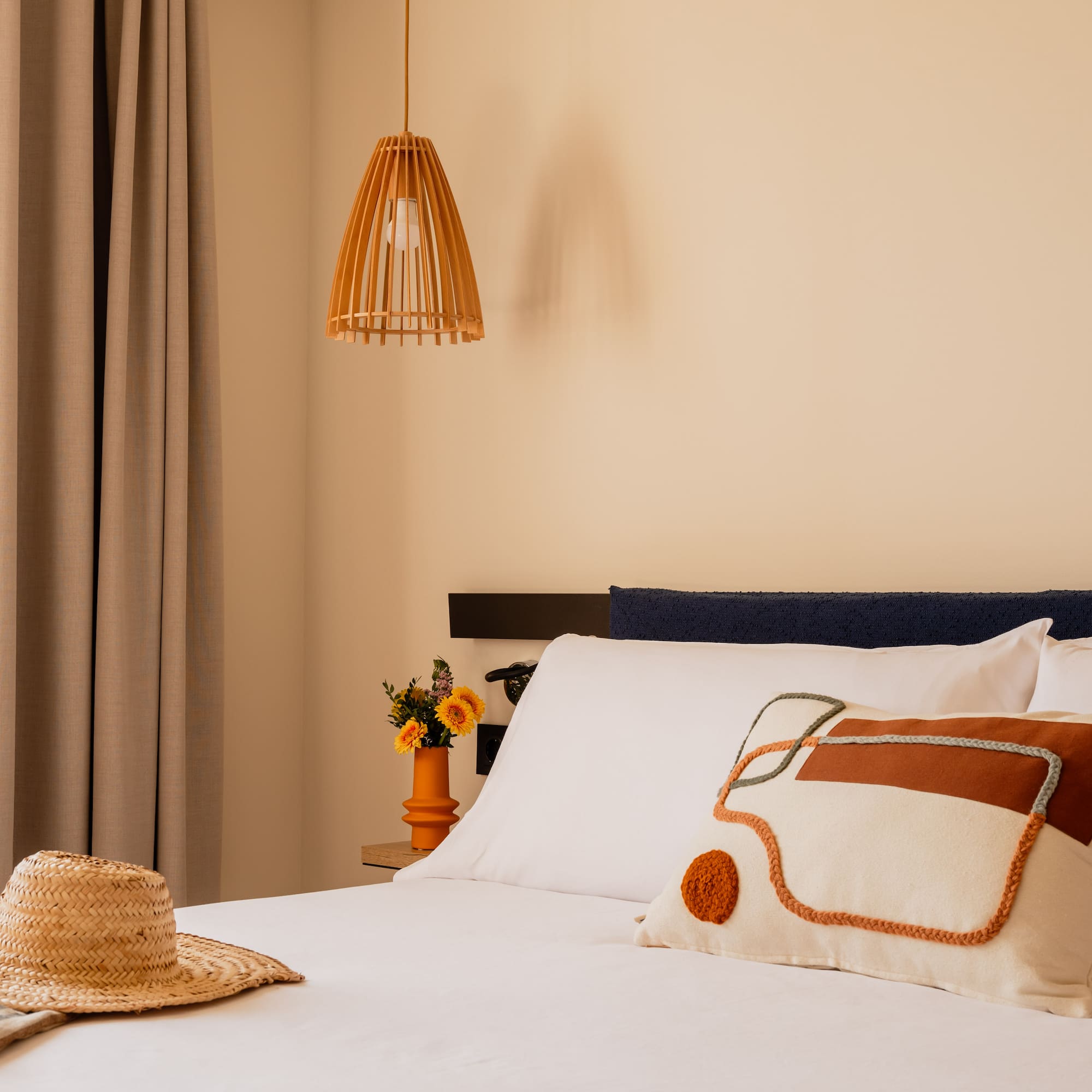 a bed with a hat and pillow