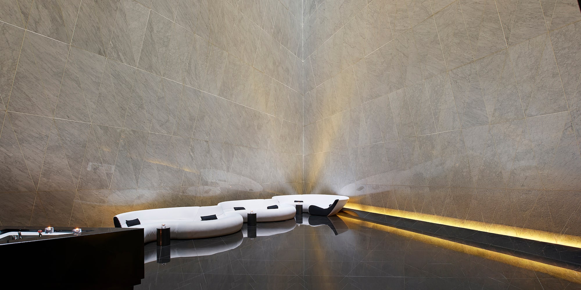 a room with a corner of a wall and a couch