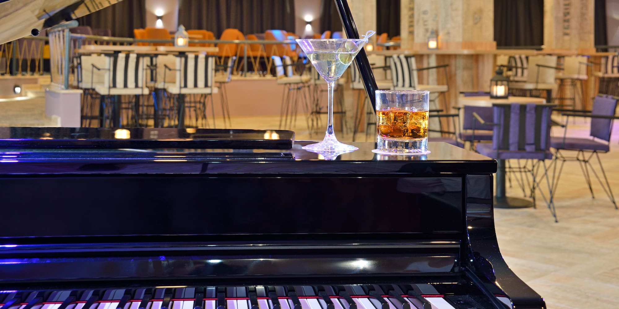 a glass of alcohol on a piano