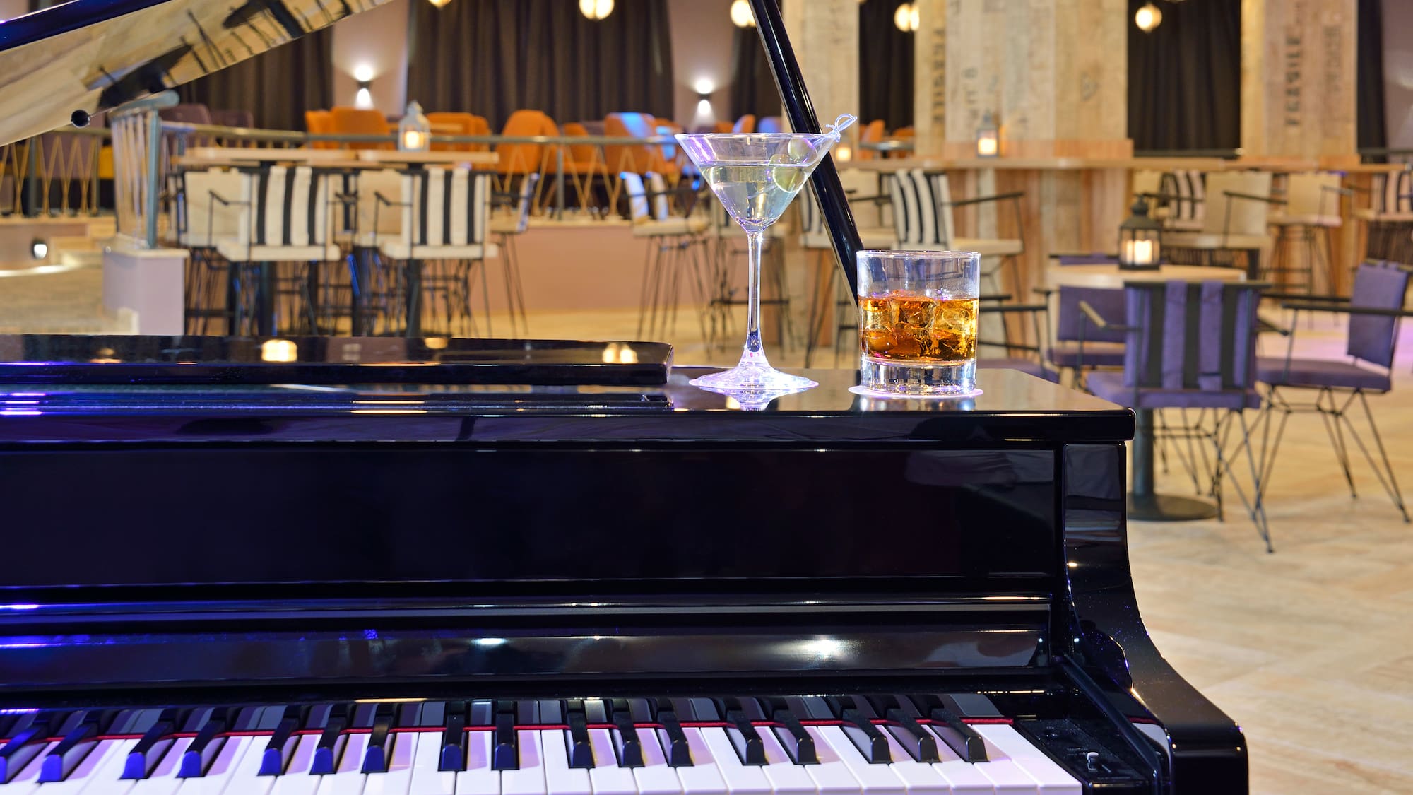 a glass of alcohol on a piano