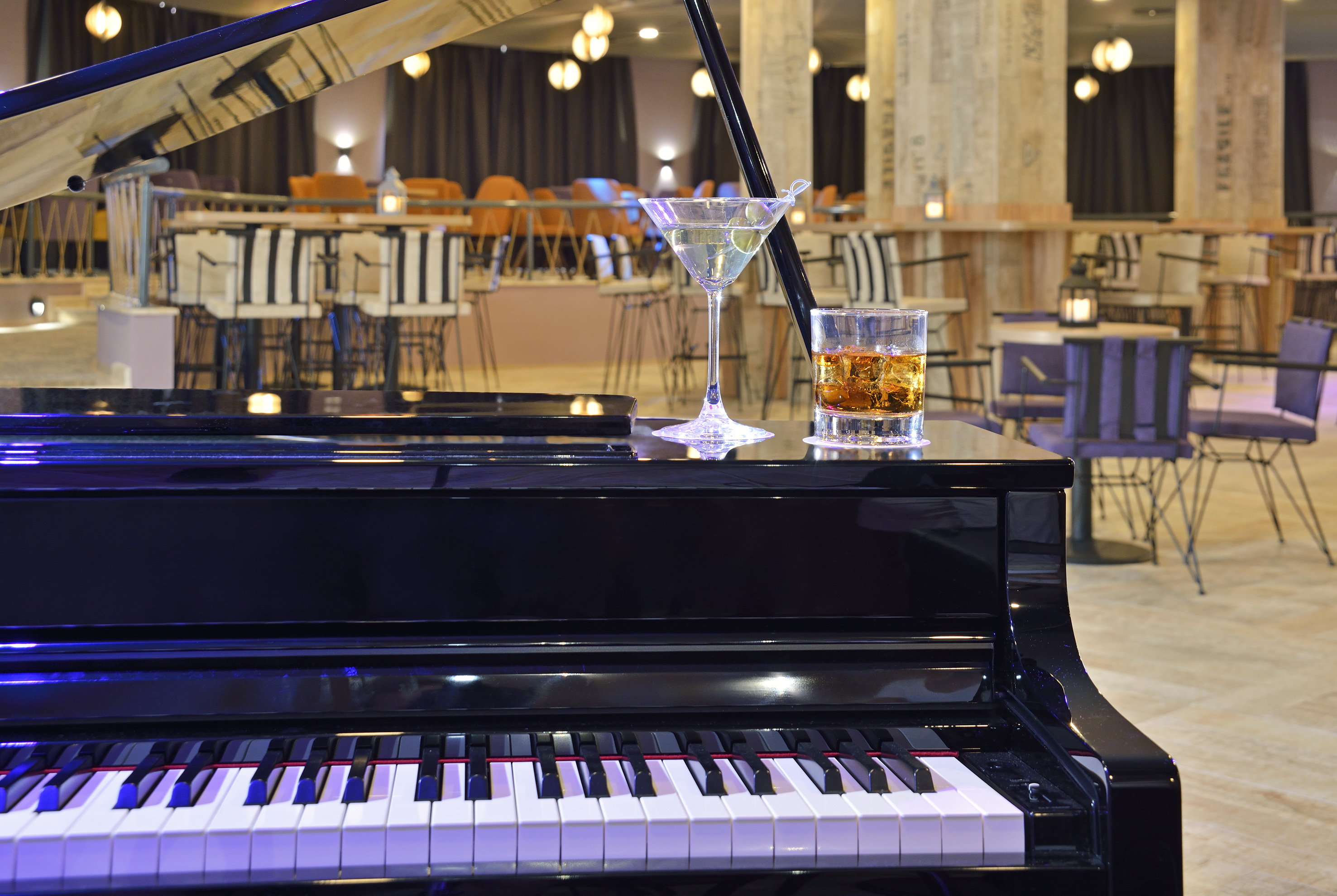 a glass of alcohol on a piano