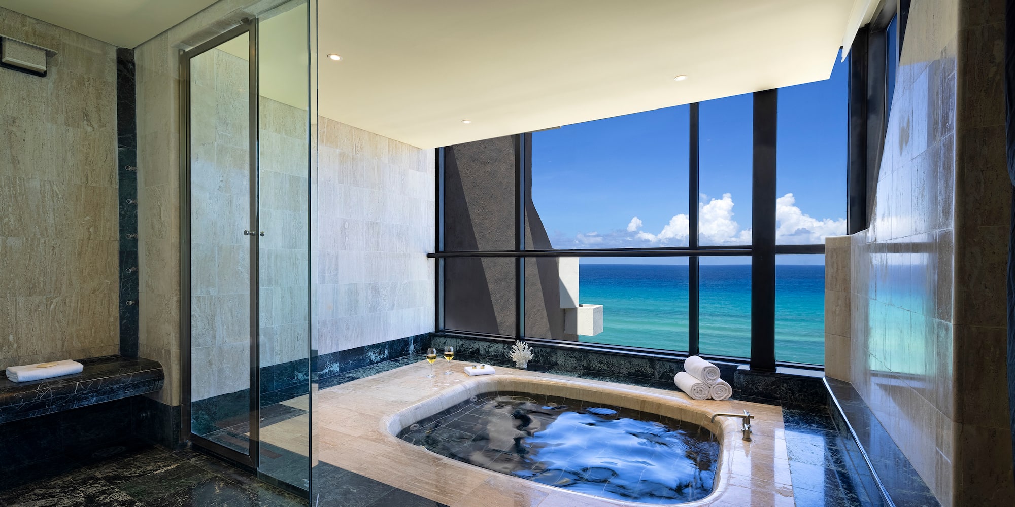 a bathroom with a hot tub and a large window