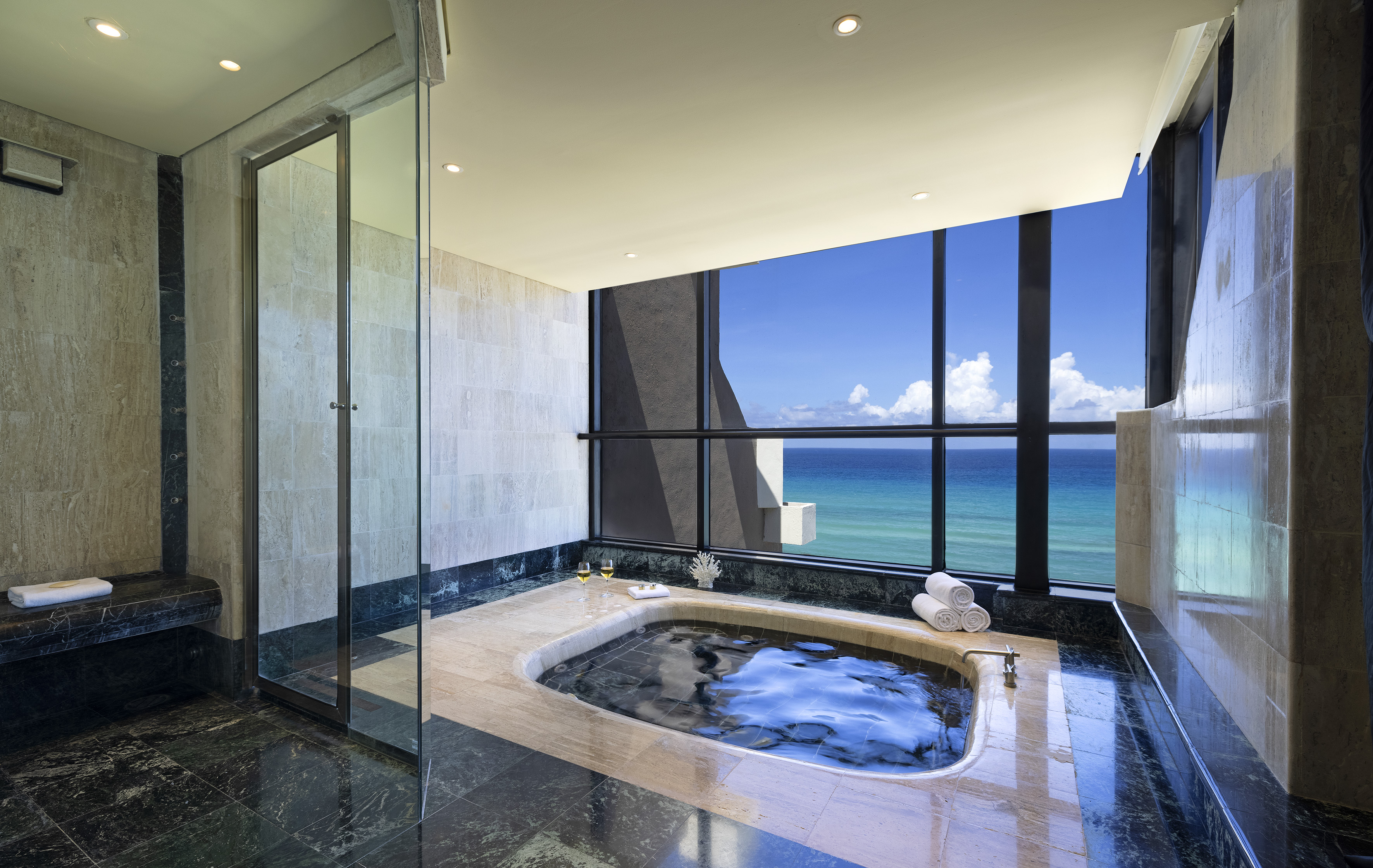 a bathroom with a hot tub and a large window